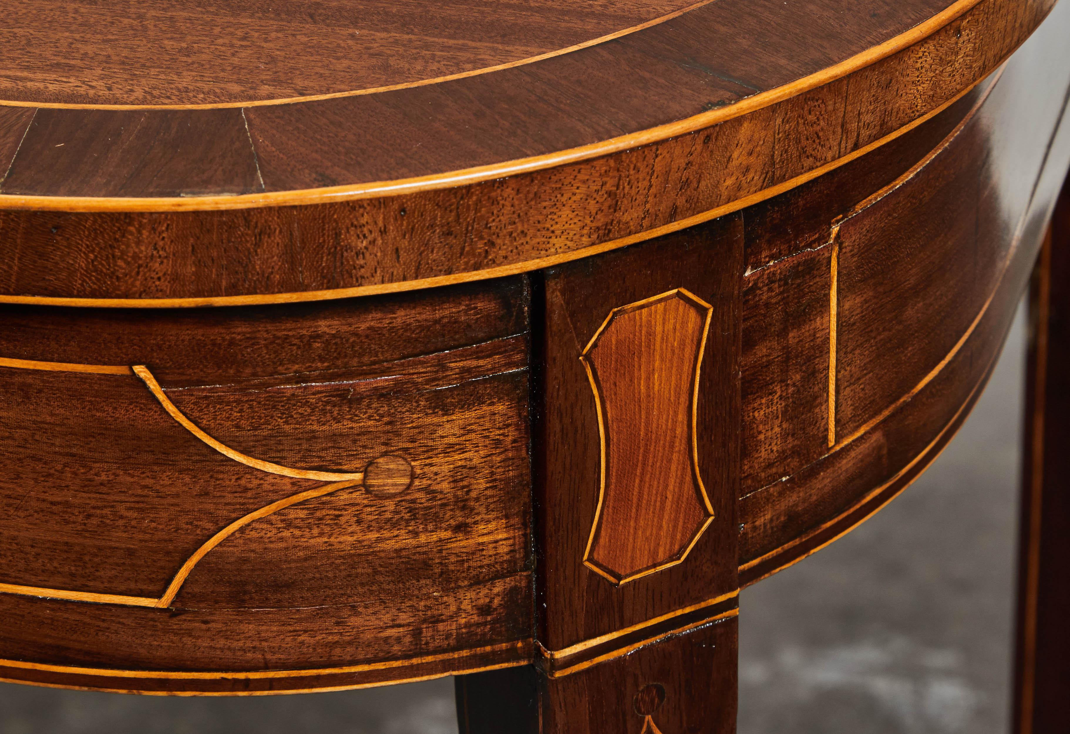 A handsome 19th century English mahogany inlaid console table featuring an inlaid squared tapered set of feet.