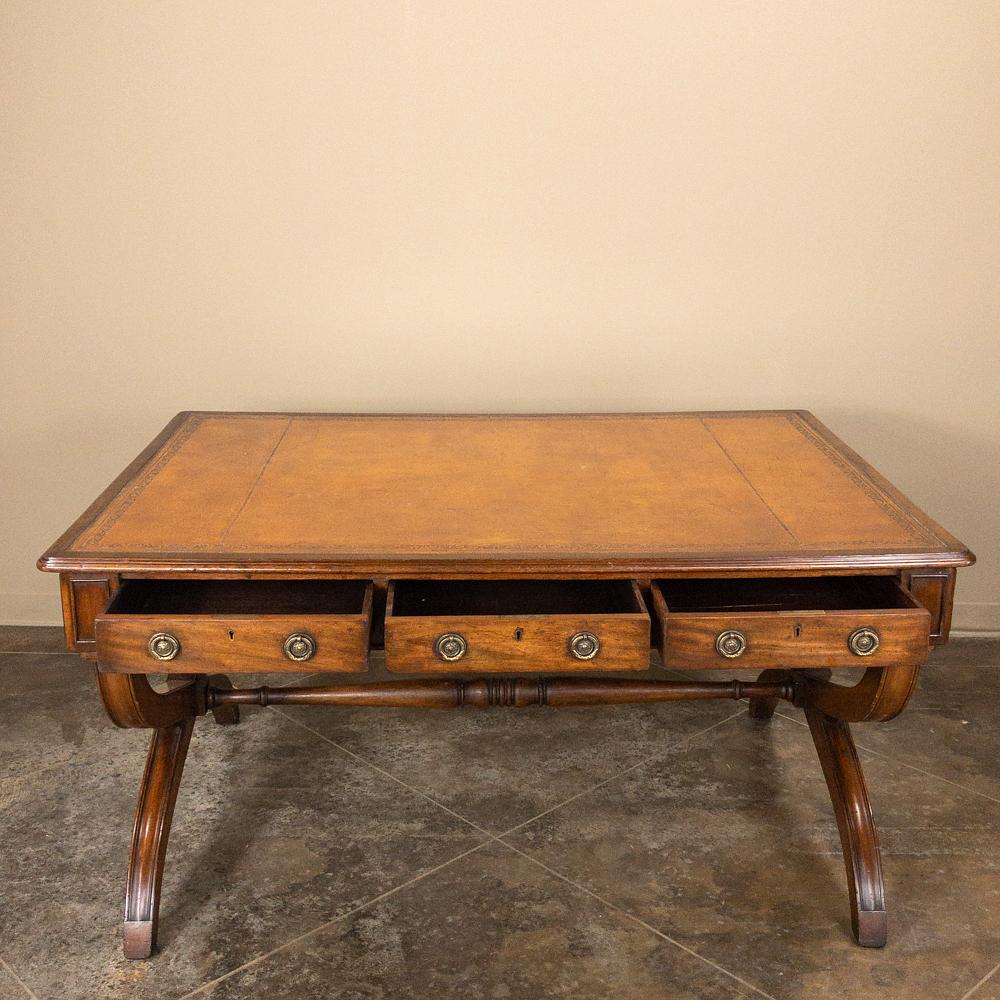 19th century English mahogany leather top desk represents the essence of stately elegance, with crossed leg supports connected with a turned stretcher, three drawers across the apron and a tooled leather top for your enjoyment!
circa