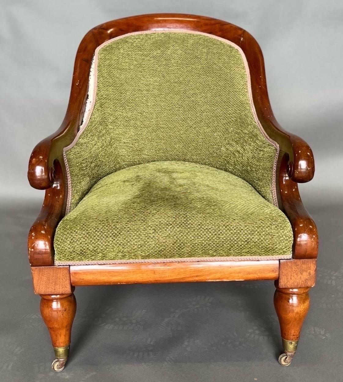Cozy 19th century upholstered English mahogany library chair. Great color and scale. Fabric ready to use as is or could easily be reupholstered. 