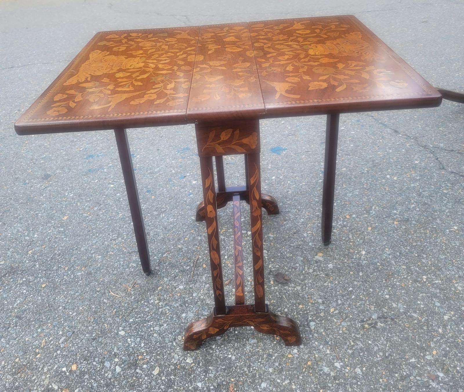 Petite, English Regency, drop-leaf, mahogany side table with amazing symmetrical marquetry, boxwood inlay work throughout and beautiful trestle legs with inlays. The table extends from 7..5 to 25.5 inches in width and 21.5 in depth and stands 22.75