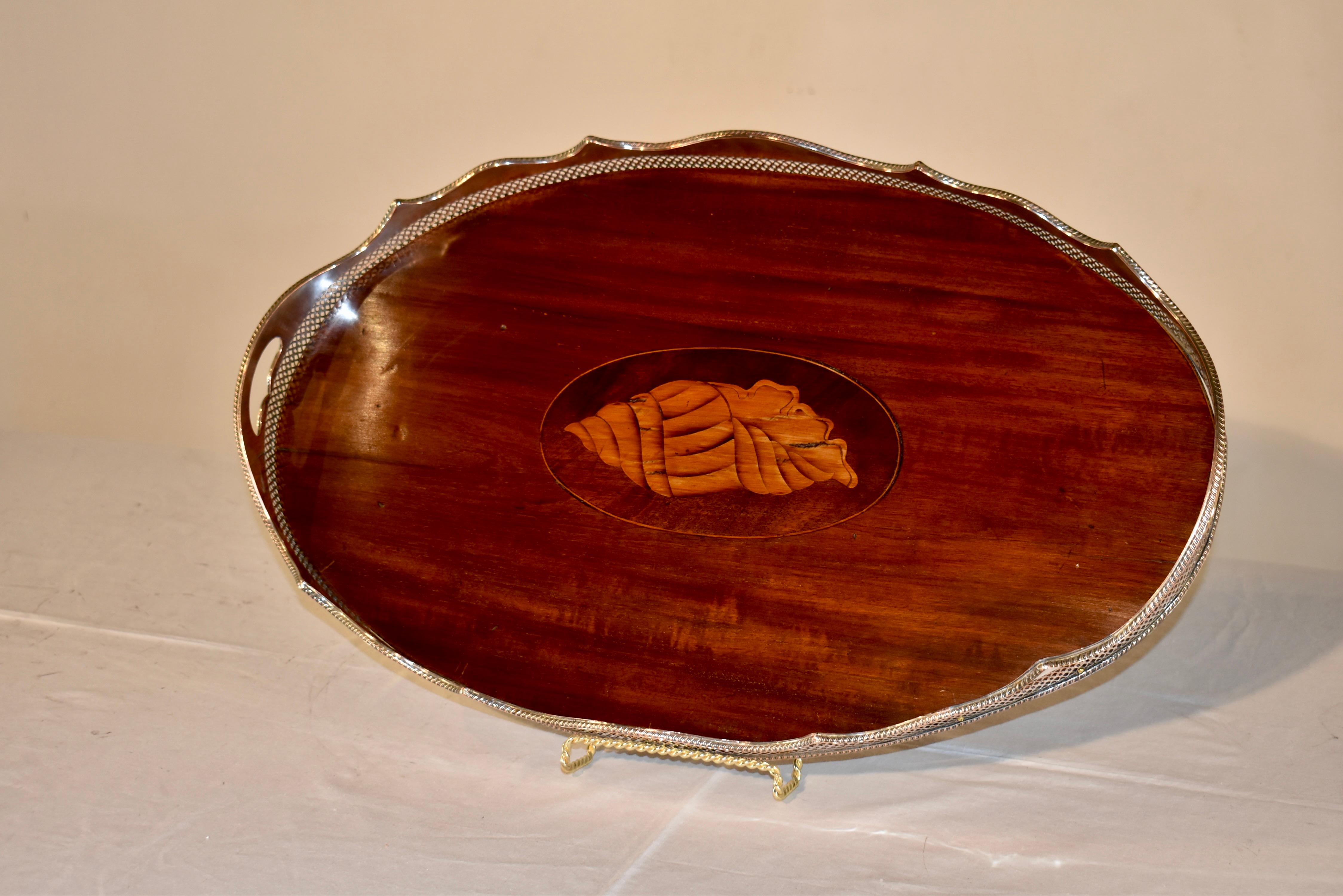 Period Edwardian tray made from a single piece of nicely grained mahogany.  The tray has a central medallion with an inlaid shell, made from satinwood and surrounded by a border of boxwood.  The tray itself has a lovely pierced and scalloped gallery