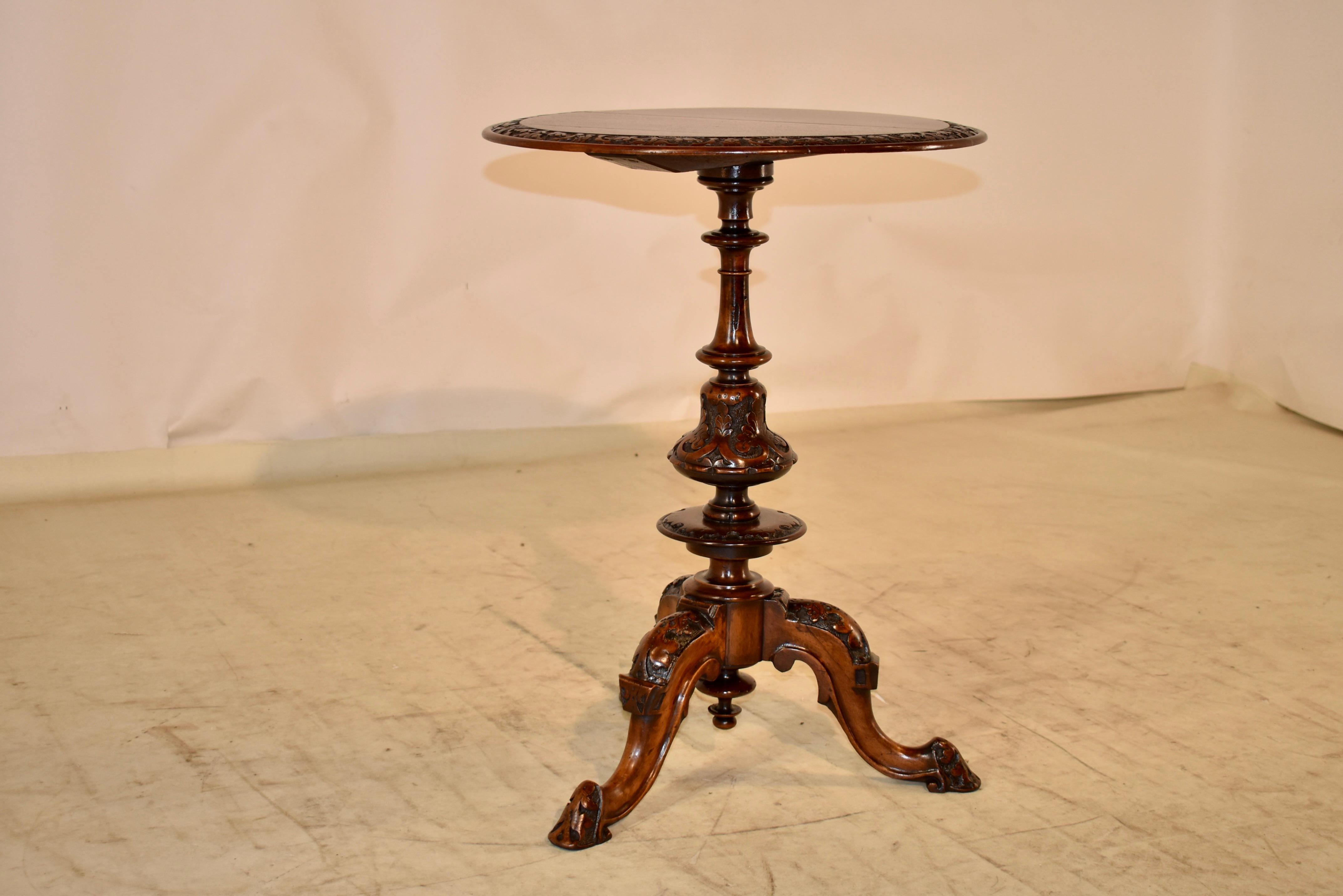 Early 19th century mahogany side table from England. The top has a banded edge which is hand-carved decorated and beveled. The top is supported on a hand turned and hand carved decorated pedestal, ending in a tripod base. The base has three