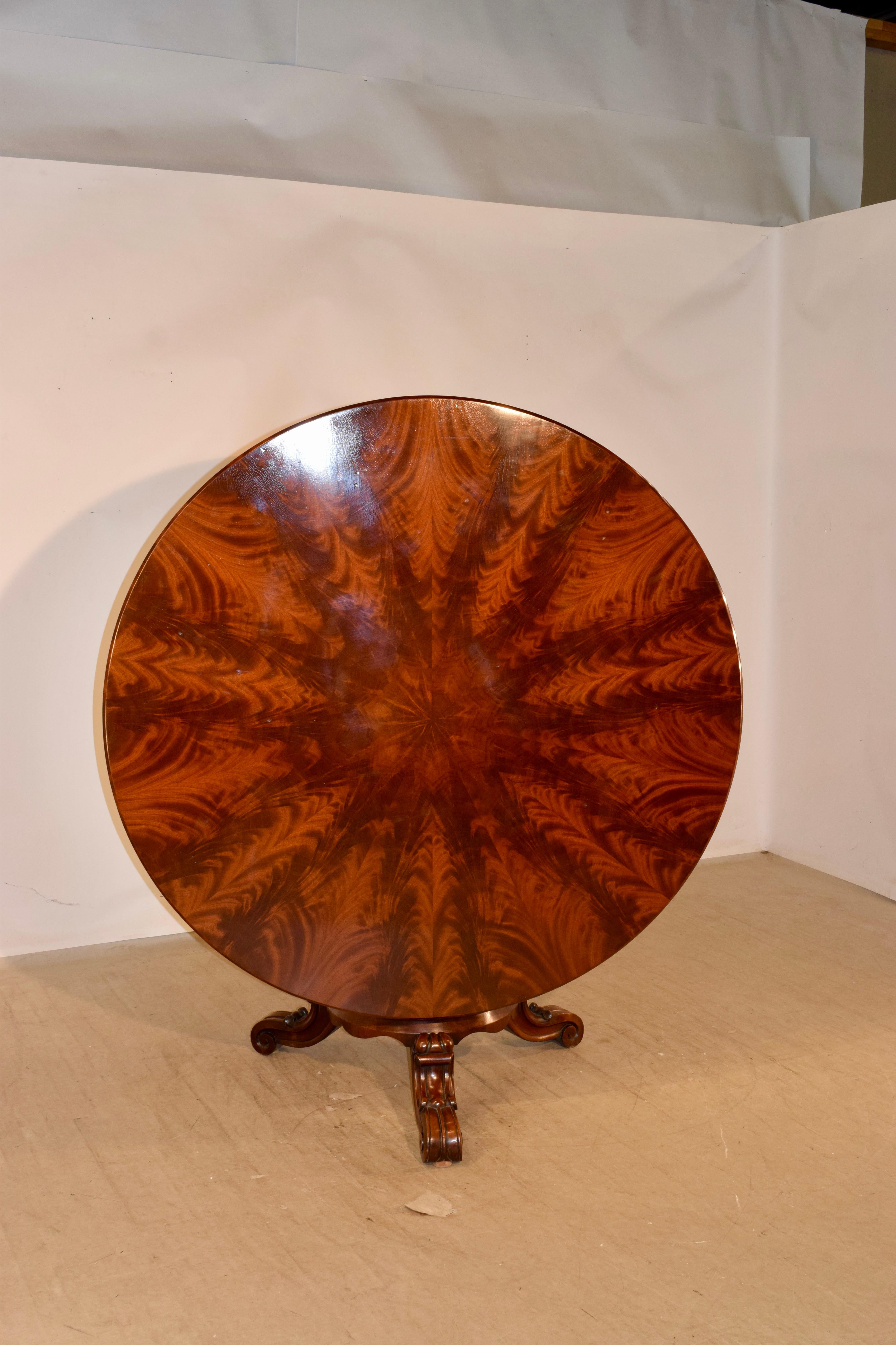 19th century English tilt-top table made from mahogany. The top is made from the most glorious flame mahogany and has been placed in a pattern to look like a starburst. It is one of the finest tables we have ever had the pleasure to offer. The top