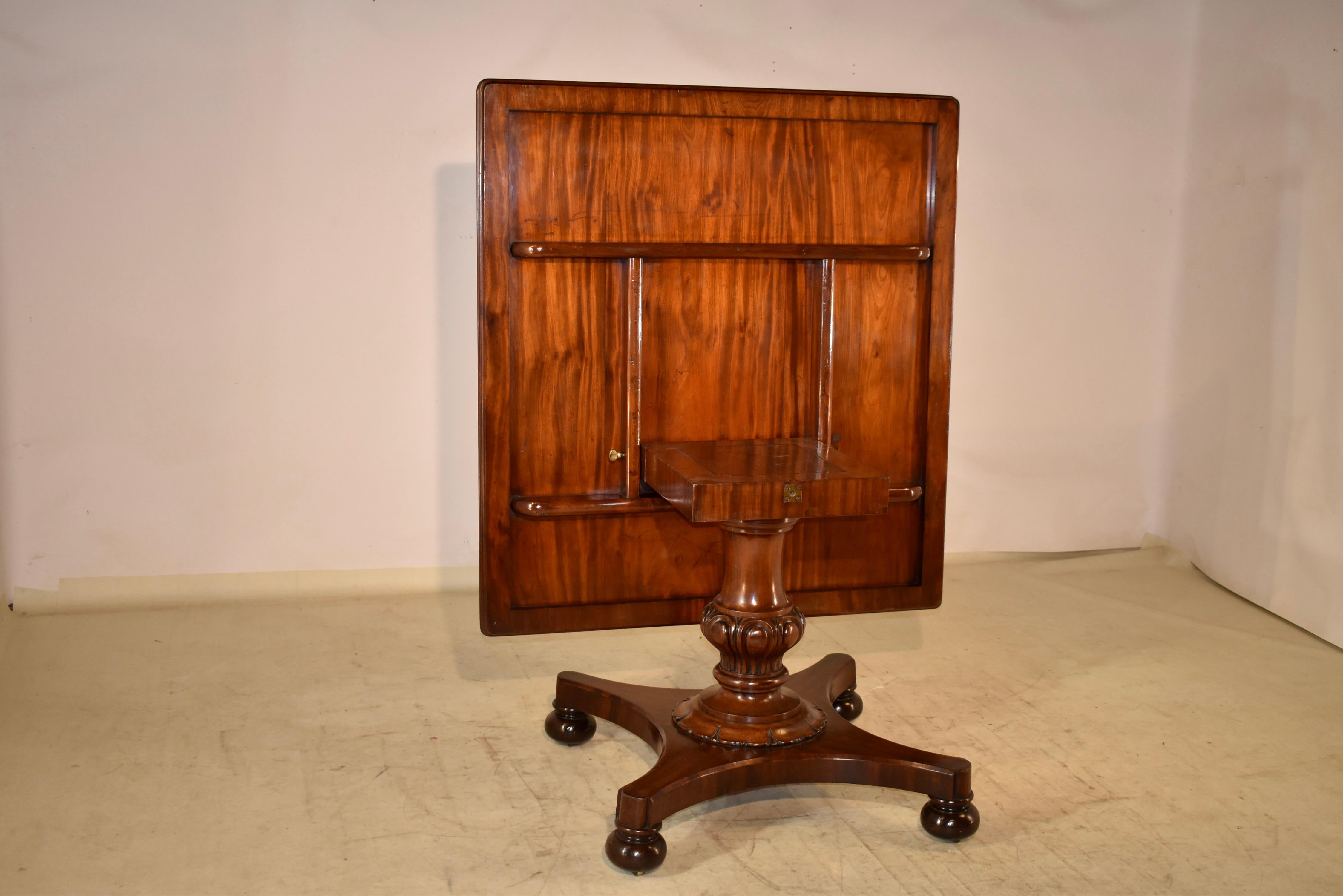 19th century Mahogany tilt-top table from England. The top is made from the most wonderful and richly grained mahogany you have ever seen. The top has a beveled edge and it sits on a hand turned pedestal base with bulbous turnings and hand carved