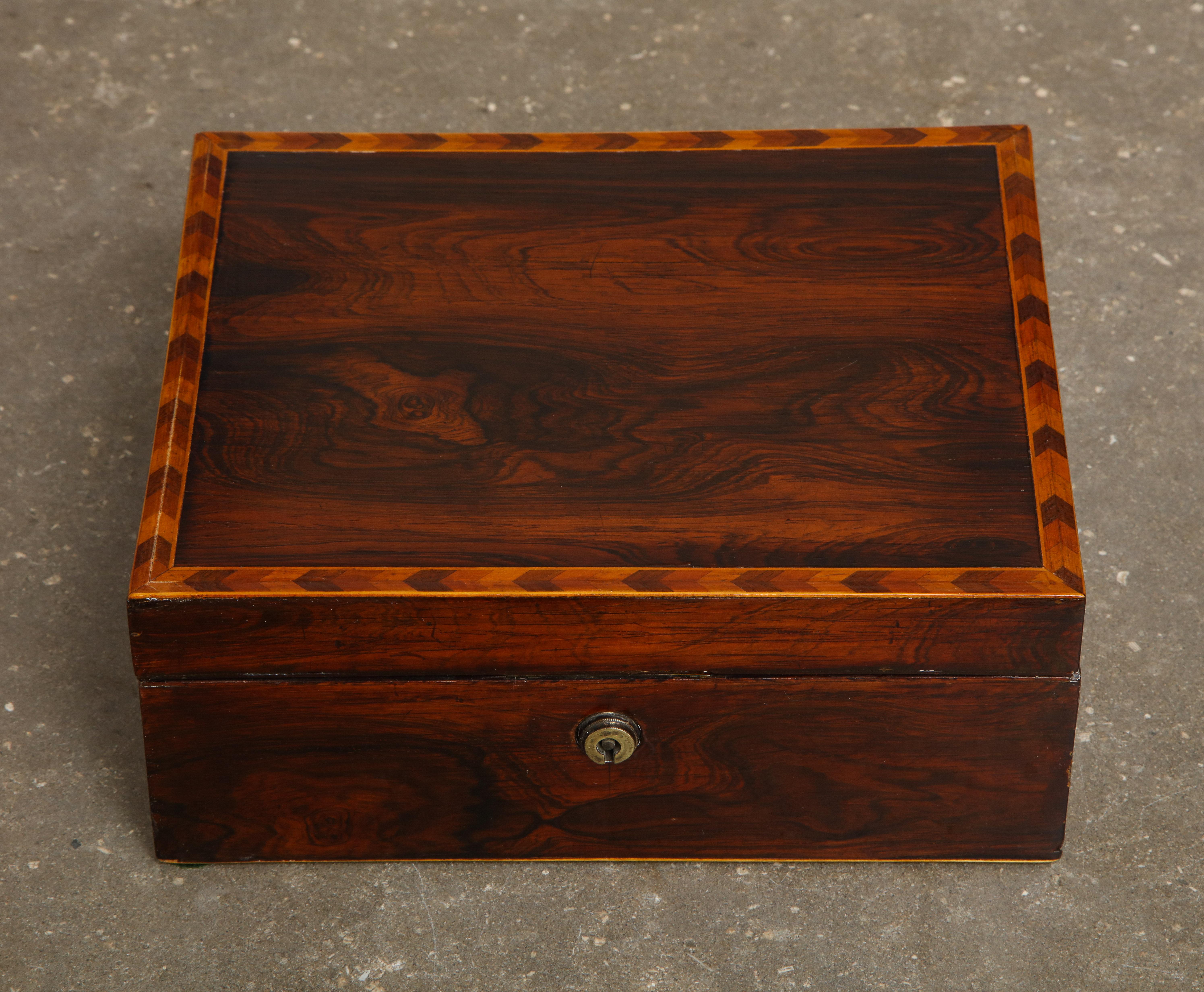 19th century English mahogany trinket box with inlaid border and lined interior. Brass fittings, stamped 