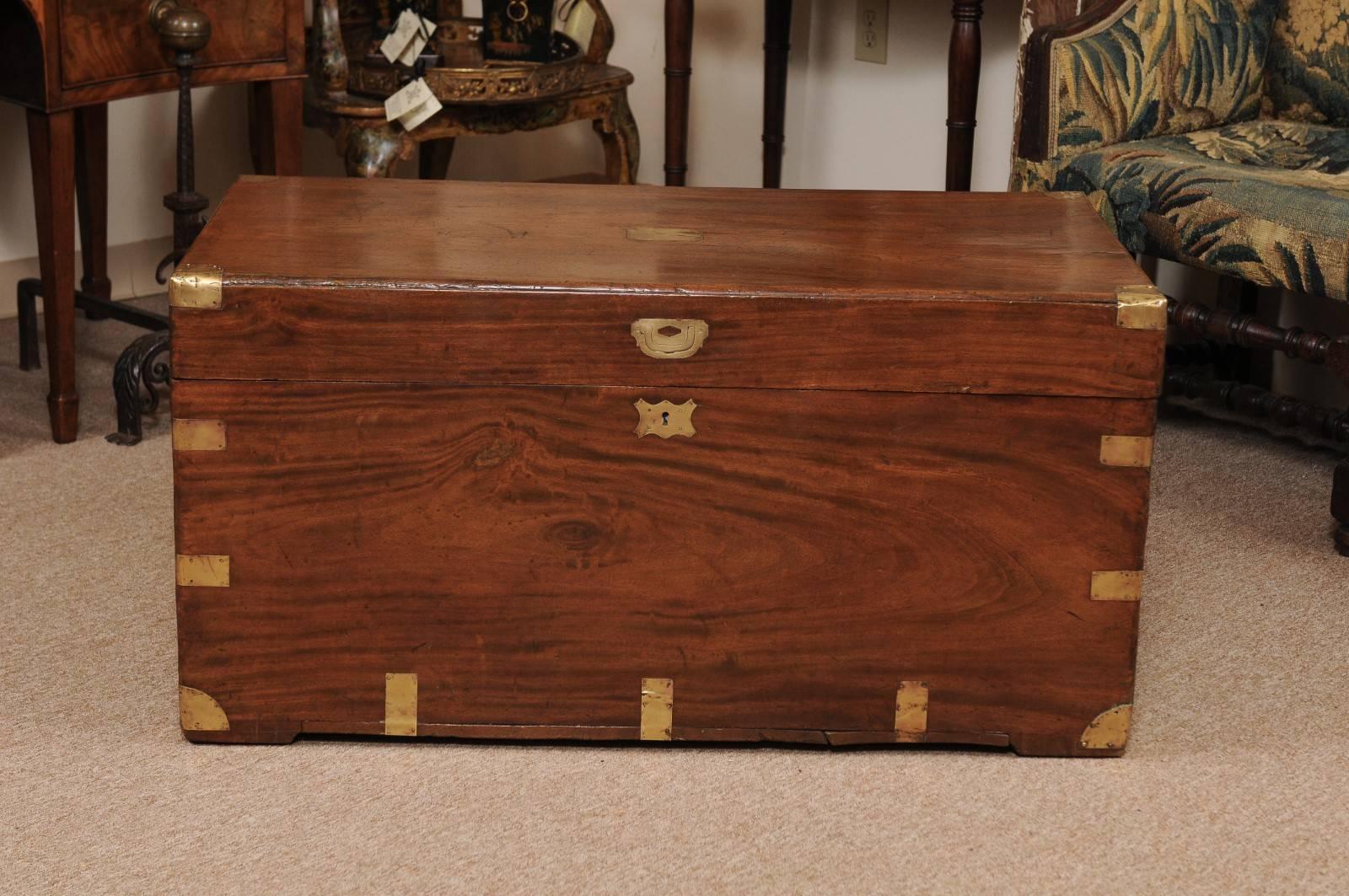Brass-mounted mahogany trunk with hinged lift top and brass handles, England, 19th century. This piece is very versatile and could be used as a storage chest, coffee table, bench, etc.