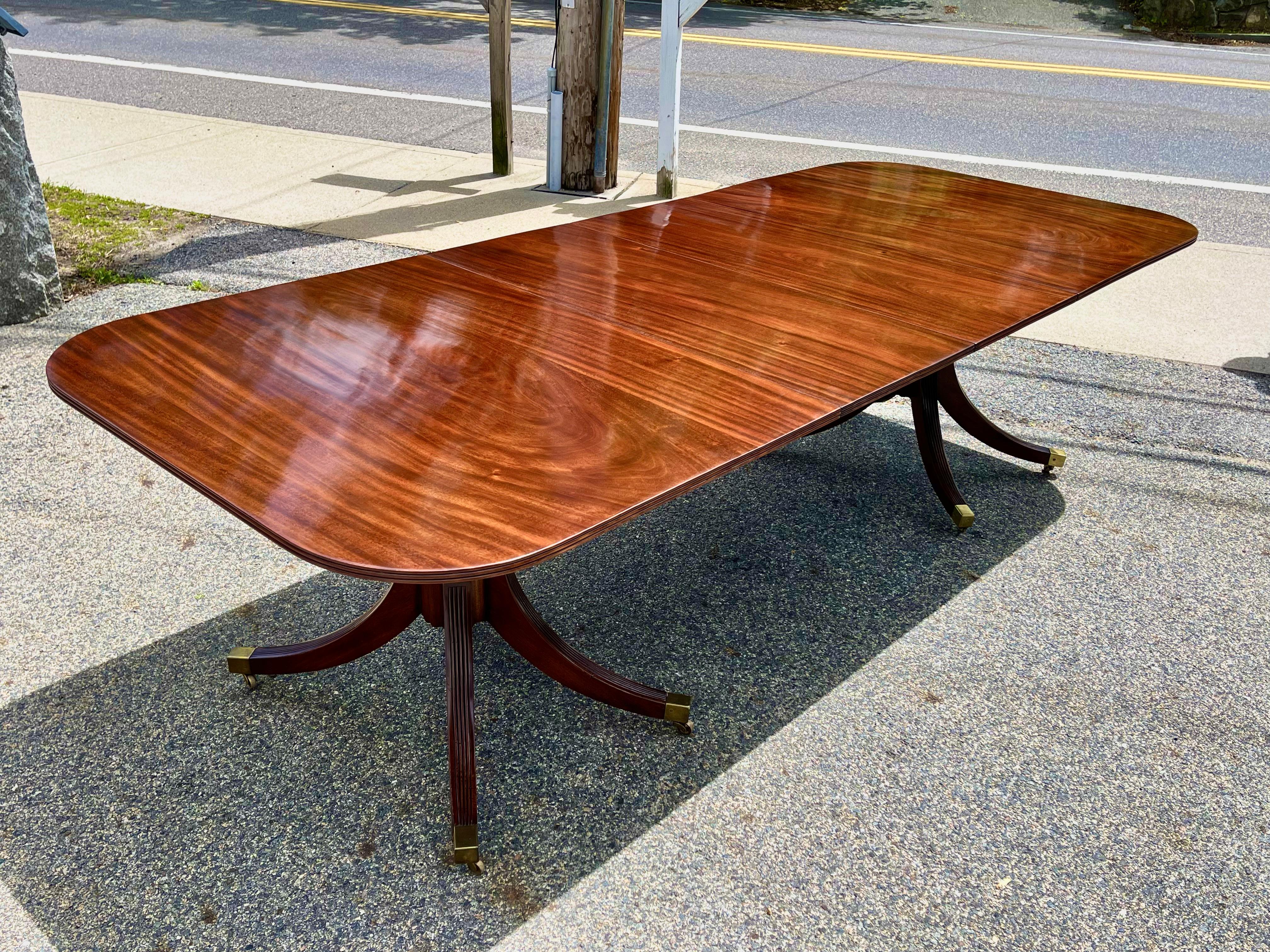 19th century English or American Two Pedestal Mahogany Dining Table. Original Leaves. GREAT color and patina. No previous breaks to pedestals. Stable and solid.

Exquisitely bookmatched boards with flamboyant solid mahogany.