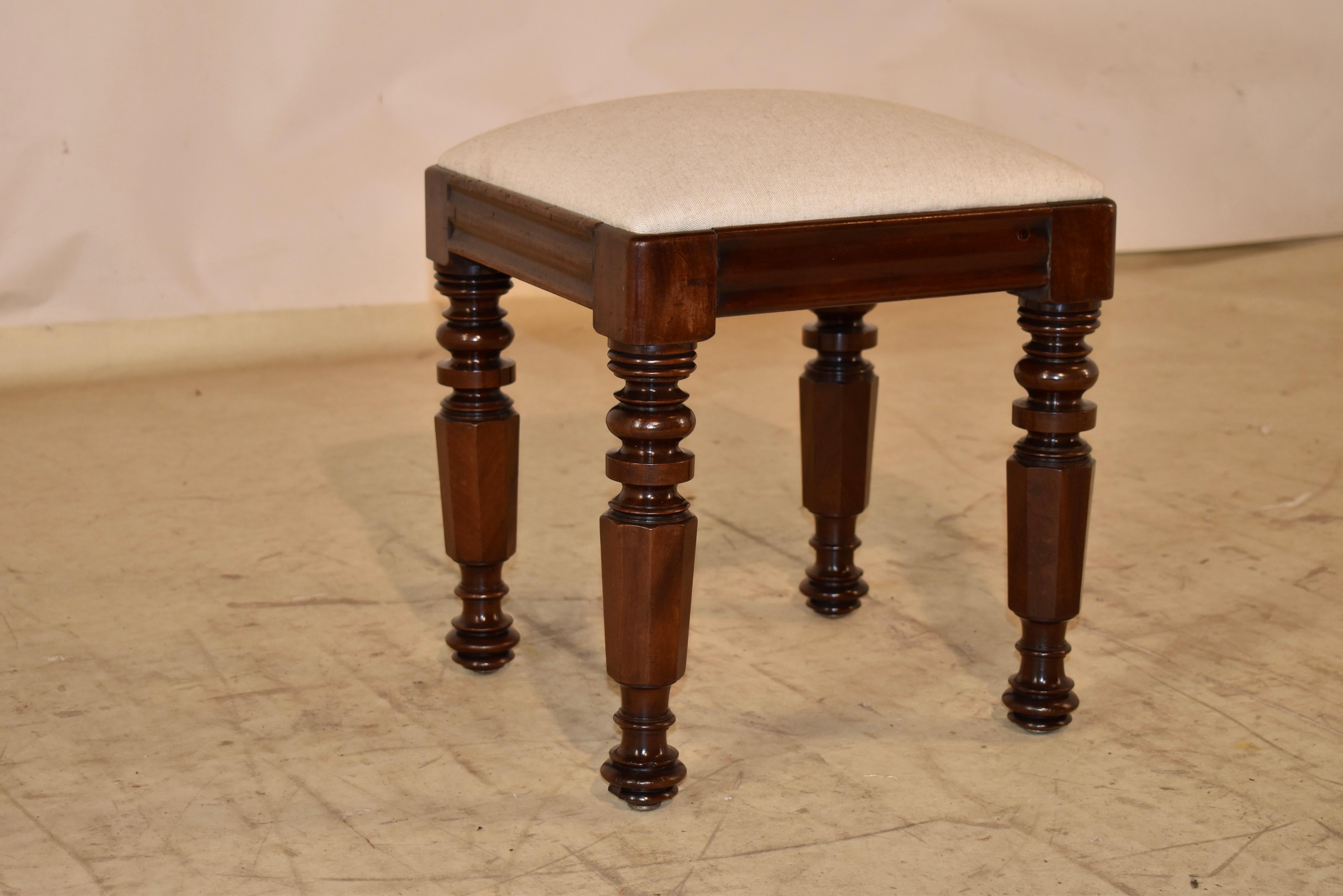 Lovely 19th century English mahogany stool with a newly upholstered linen seat.  The frame of the stool is made from mahogany, and has a molded apron that adds a bit of additional design interest to the piece.  The legs have been wonderfully hand