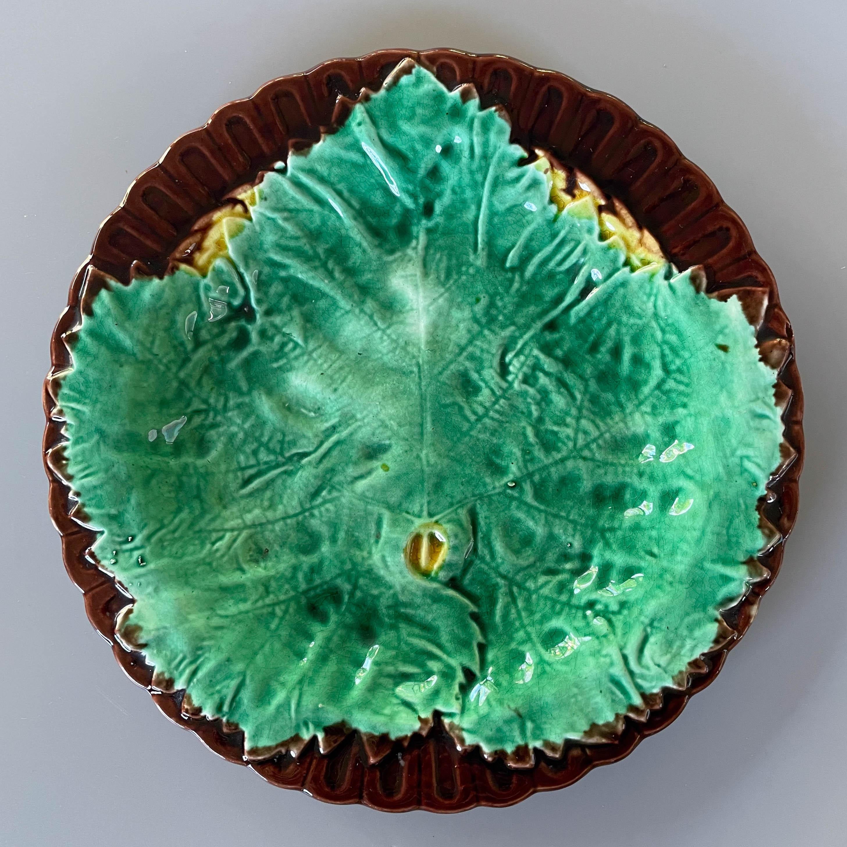 A 19th Century English Majolica glazed ceramic begonia leaf plate with a single green leaf on dark brown ground with yellow accents. Mottled green, brown and yellow on reverse. Circa 1880-1900.
8.5