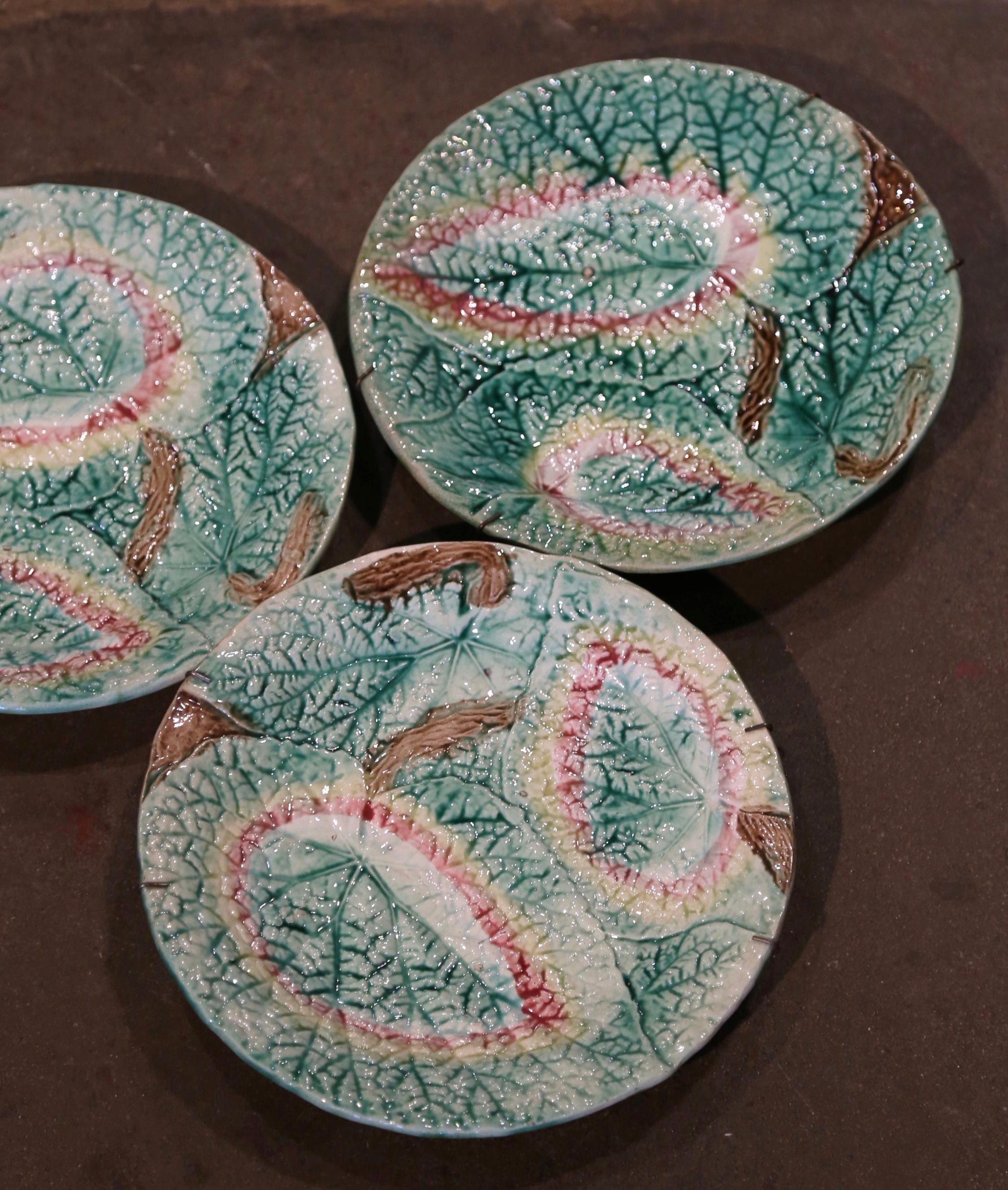 Decorate a wall of a shelf with this colorful set of decorative plates. Crafted in England circa 1880, each plate is heavily textured and brightly colored with graduations of pale green to celery, with some pink and brown accents, further