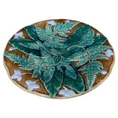 Englischer Majolikateller des 19. Jahrhunderts mit Blättern und weißen Blumen