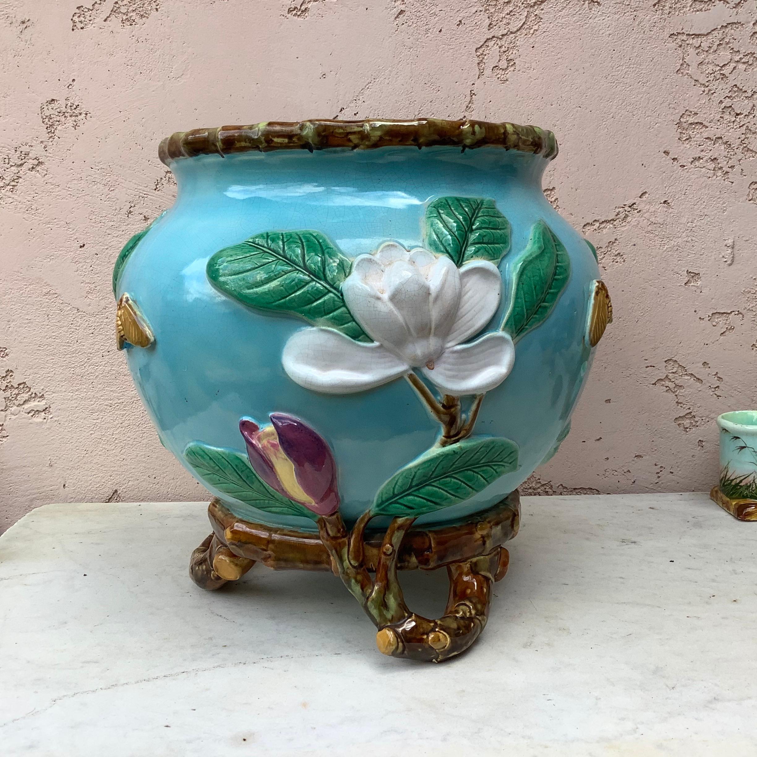 English Victorian jardiniere with magnolias and moths supported by branch form feet signed George Jones.
Impressed crescent mark shape No. 3501. 

 