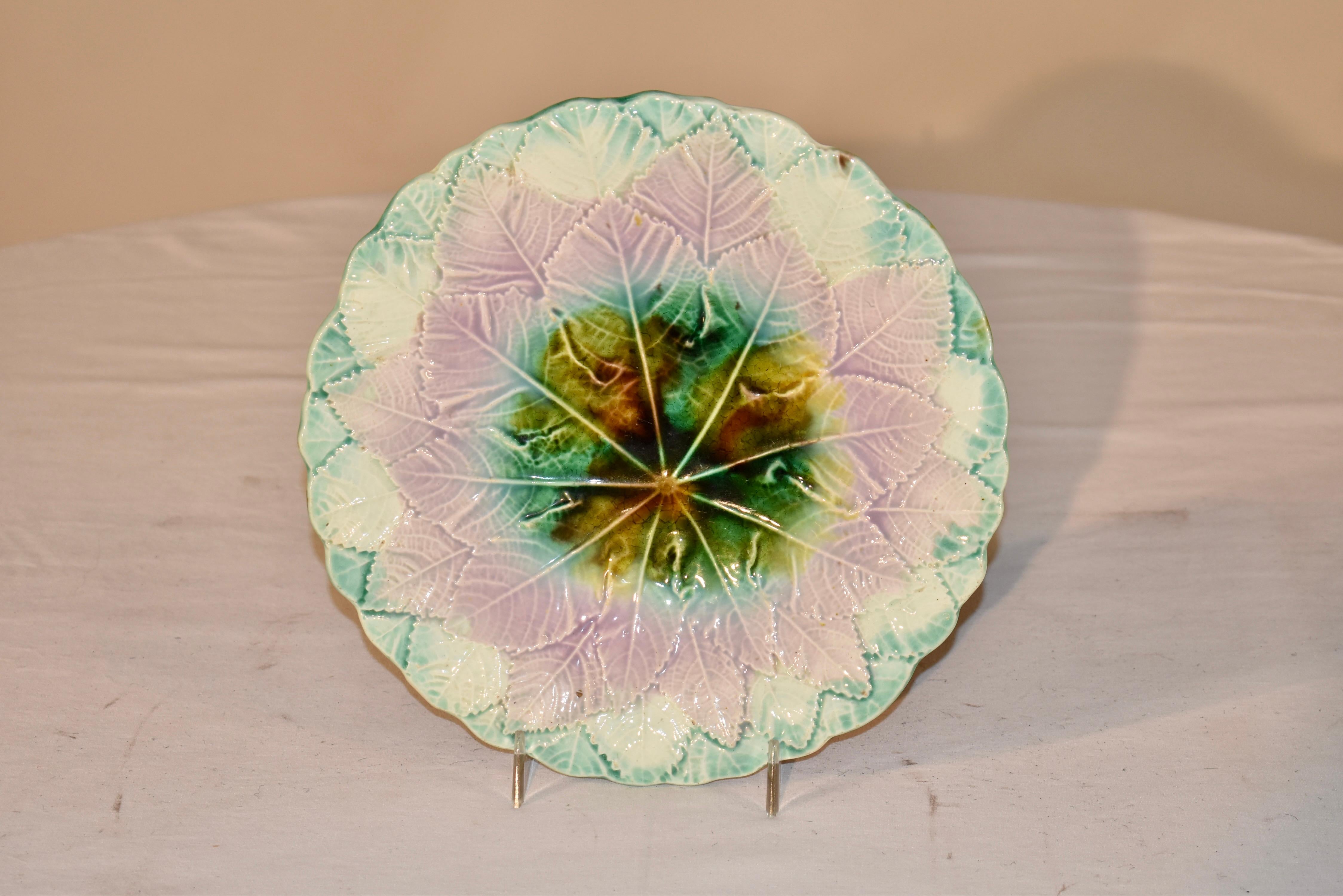 19th century majolica plate from England. The plate is in a lovely color palette with soft pastels and a stronger, more prominently tortoise colored center. The plate is molded in an overlapping leaf pattern and is truly lovely. This is a wonderful