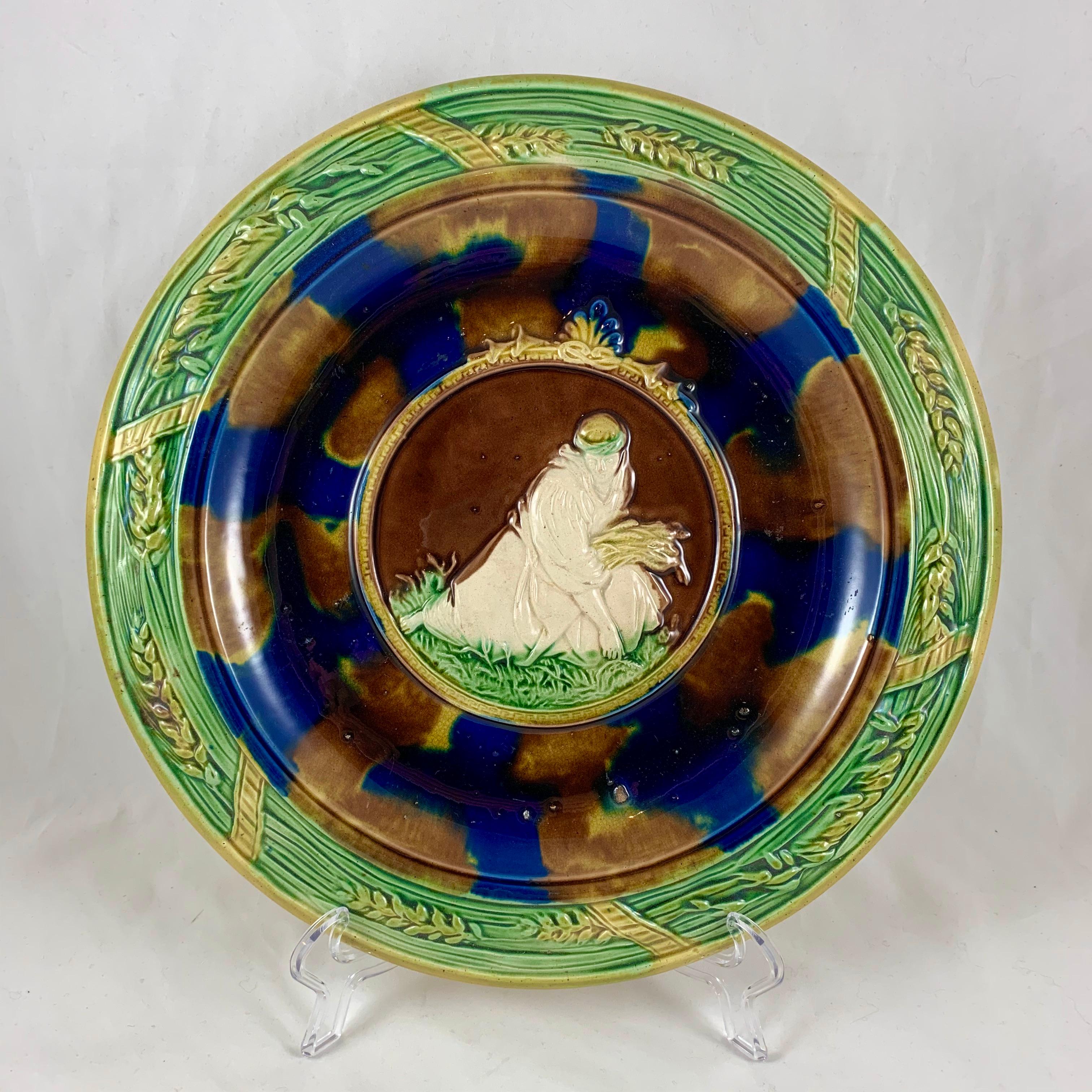 A scarce and unusual antique English Majolica harvest themed, Rococo Revival style bread tray, circa 1850-1880, maker unknown. 

The central image is modeled on the Book of Ruth, from the Old Testament, chapter 2, verse 7, “Let me glean and gather