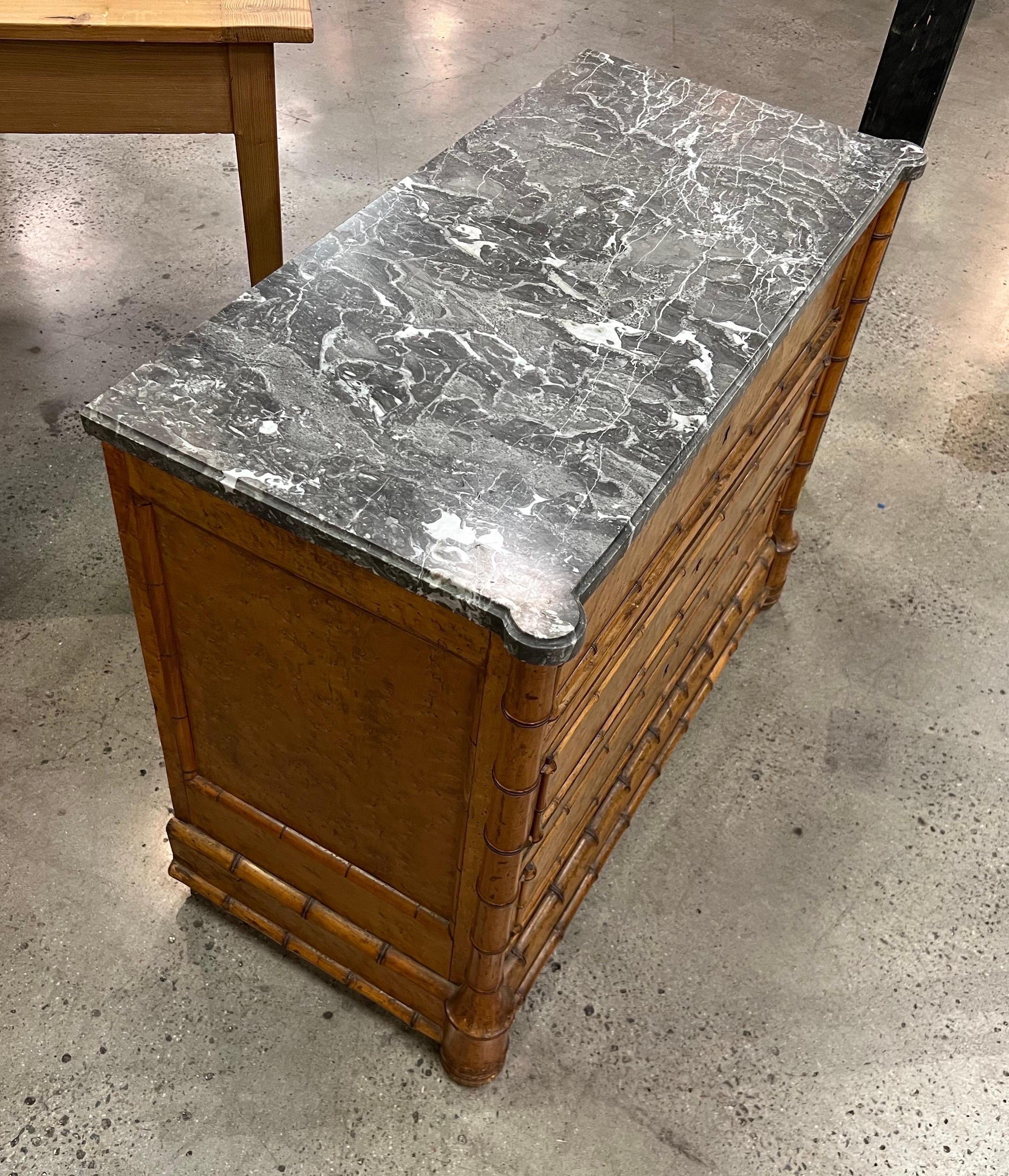Great size and patina on this 19th century English marble top faux bamboo 2 drawer commode. With original shaped marble and bottom drawer made to look as 2 separate drawers.