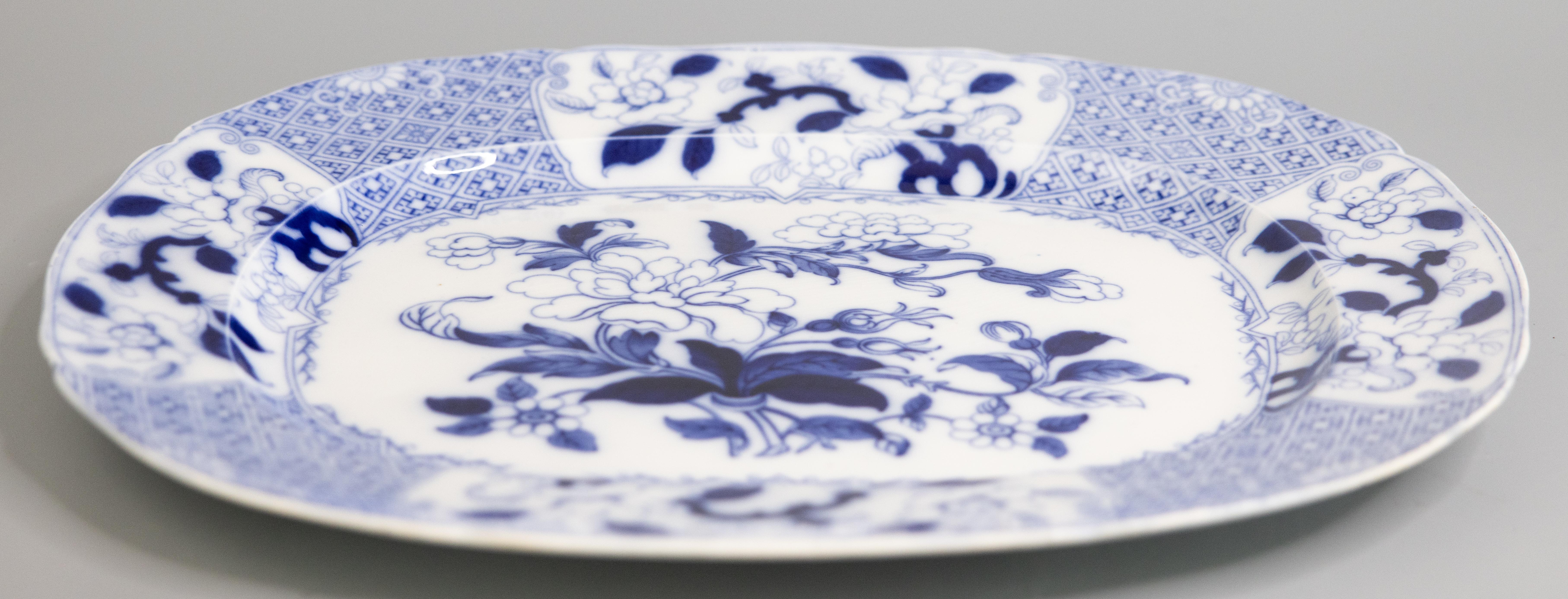 A gorgeous antique 19th-Century English Minton flow blue transferware ironstone serving platter, circa 1840. Maker's marks on reverse. This beautiful platter is a nice large size and heavy, weighing an impressive 7 lbs, with a lovely floral design
