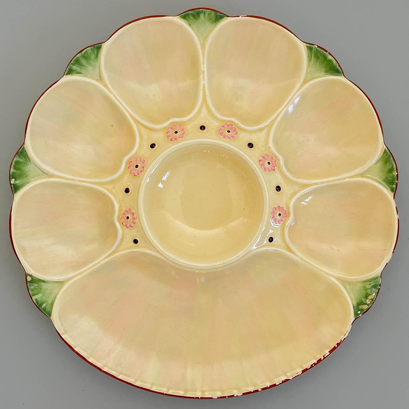 A pair of late 19th Century English Minton Majolica oyster plates with six oyster wells and a large well for crackers surrounding a center well for sauce. Luminous cream and pink glaze with pale green accents, small pink flowers and brown rim. Glaze