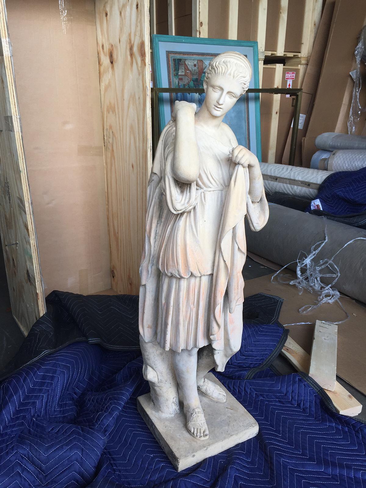 greek statue of a draped maiden crossword clue