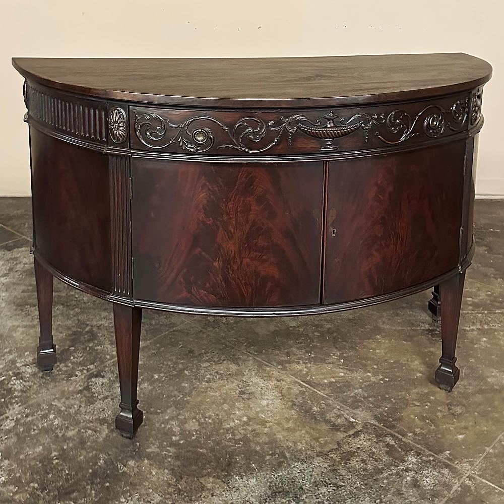 This gorgeous 19th Century English Neoclassical Demilune Buffet is the ideal choice for literally any room, as it provides a surface, storage, and the least amount of intrusion on your floor space of any design!  Hand-crafted from exotic imported