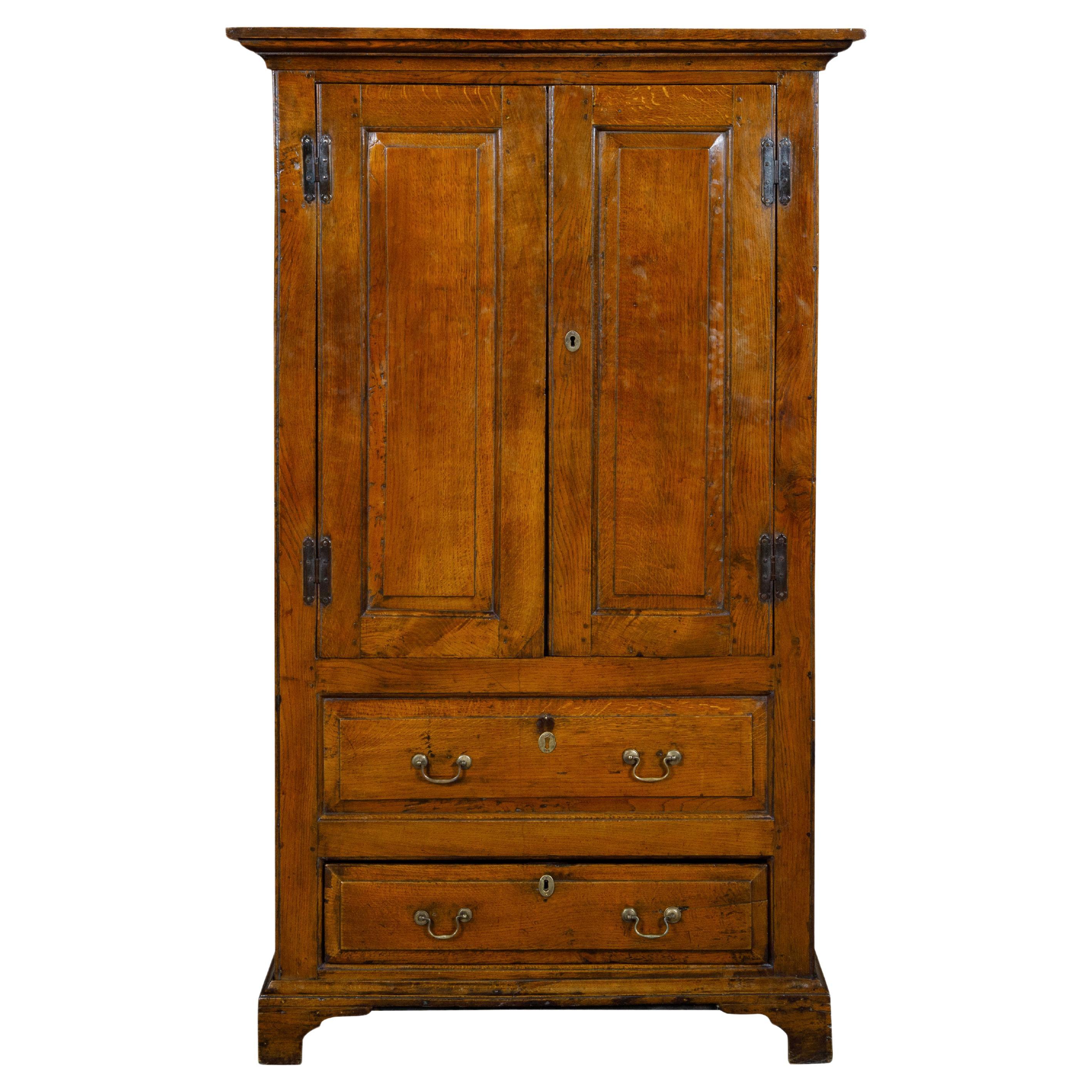 19th Century English Oak Armoire with Carved Doors, Bracket Feet, Brass Hardware For Sale