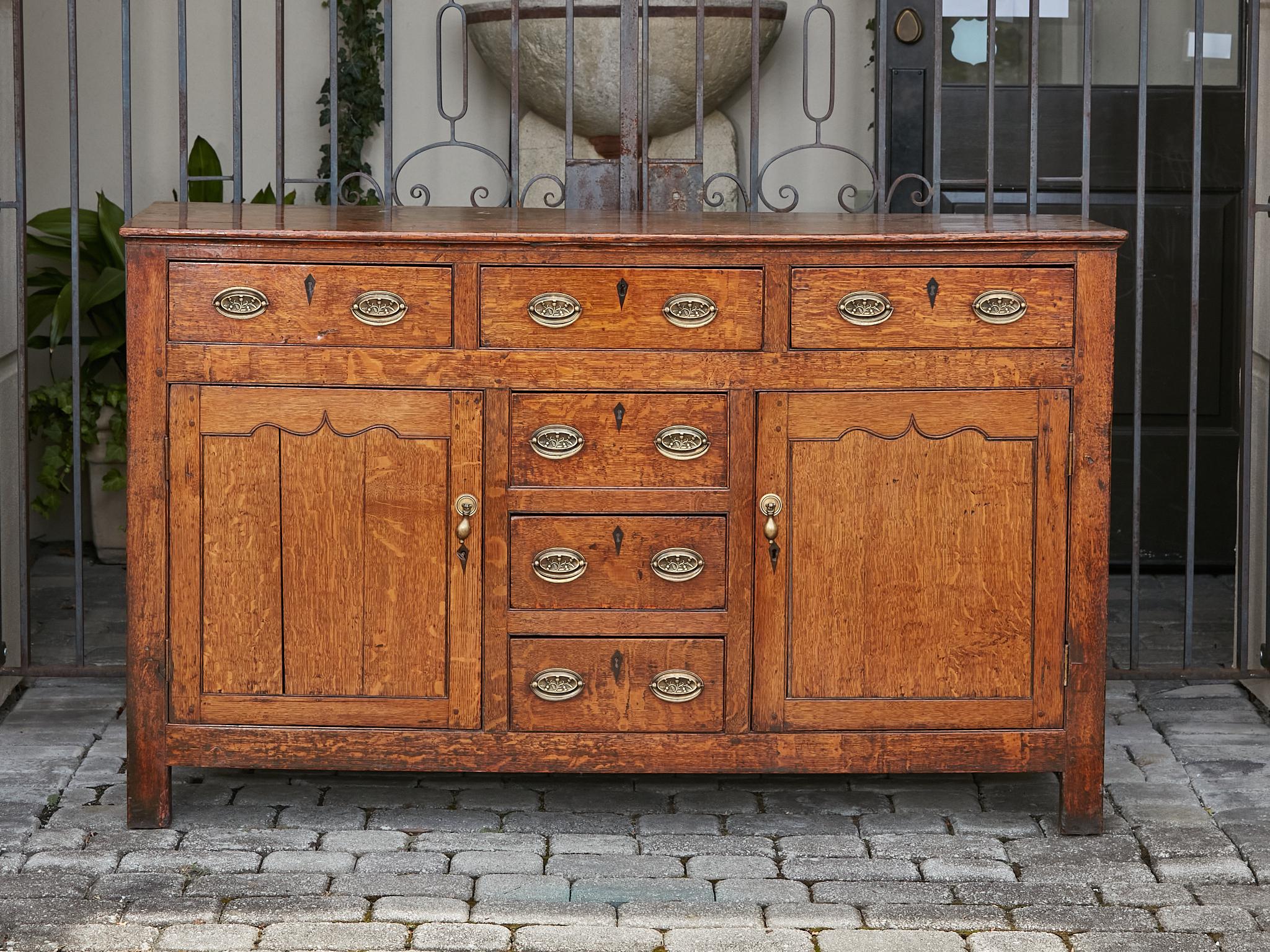 Carved 19th Century English Oak Buffet with Six Drawers, Two Doors and Brass Hardware For Sale