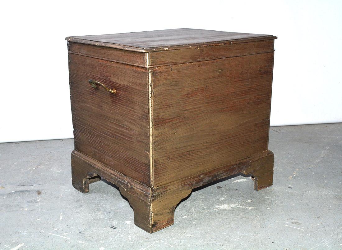 The English designed these small furniture cabinets to be used to store bottles of alcoholic beverages such as wine or whiskey. The size of this one lends itself to be used as a side, end table or coffee table.  The sides have handles allowing the