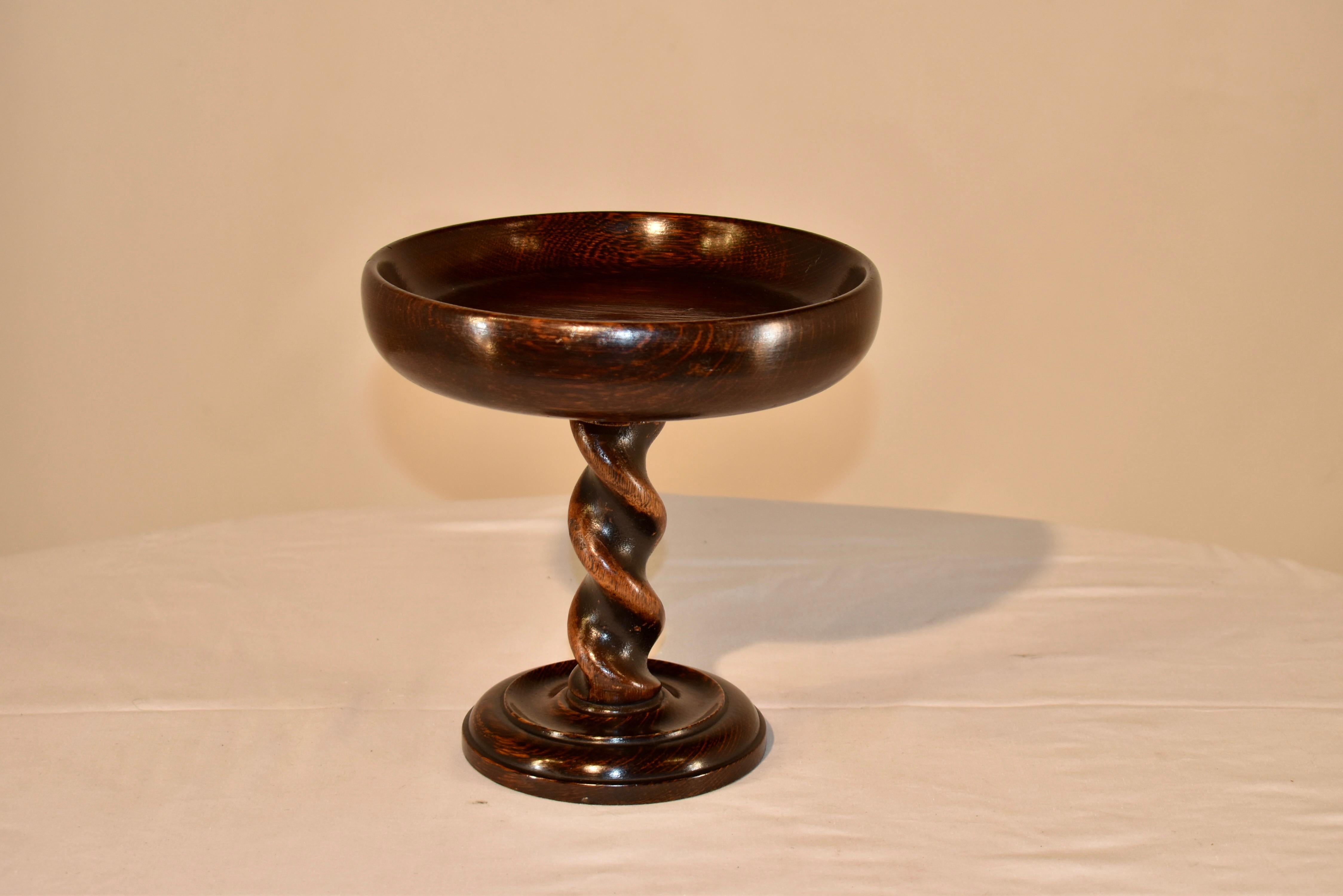 19th century oak compote from England with a nicely turned dish, supported on top of a thickly hand turned barley twist stem and resting on a hand turned and routed base. Gorgeous height and proportion.