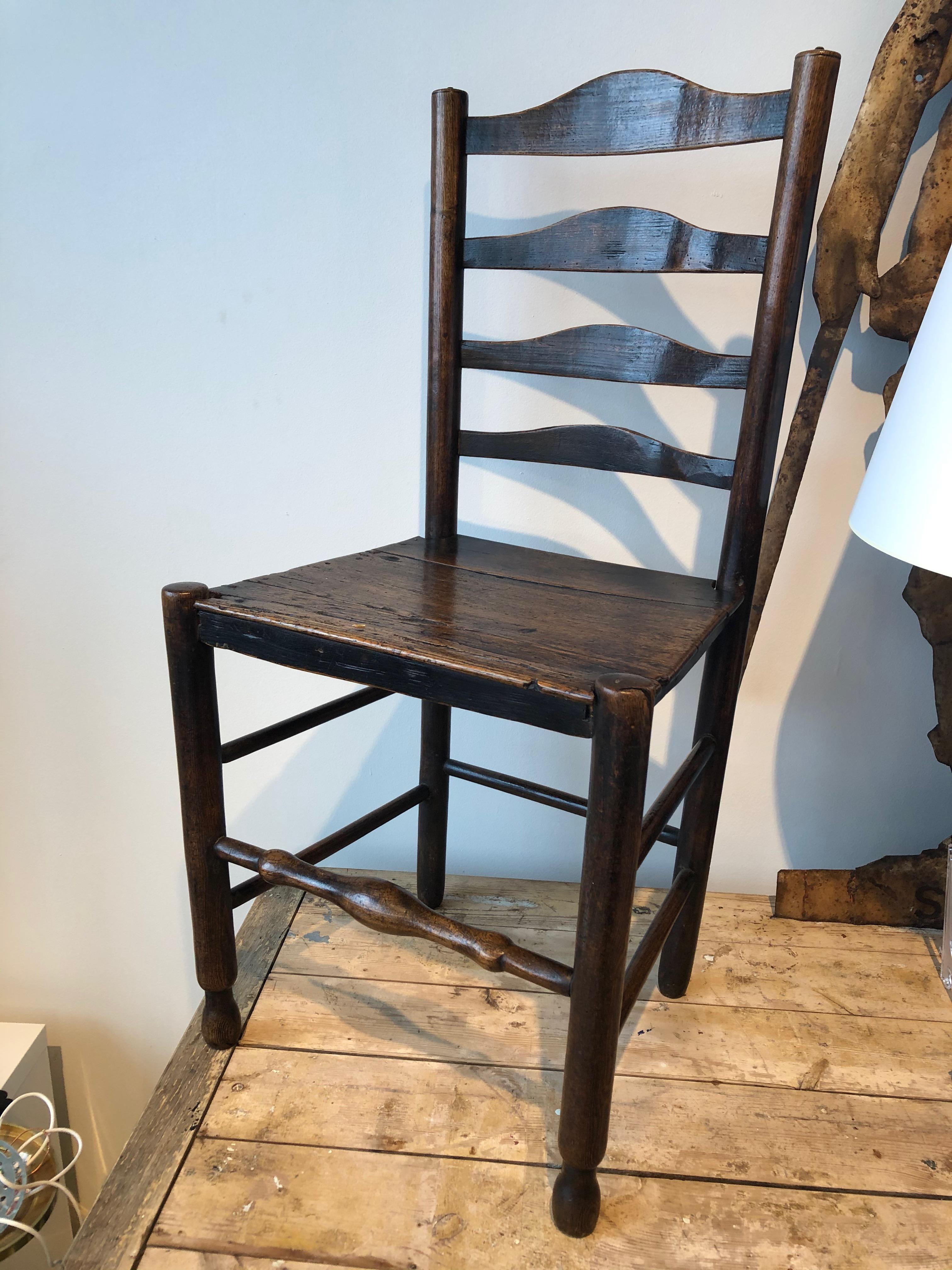 19th century English oak ladder back side chair with wooden seat.