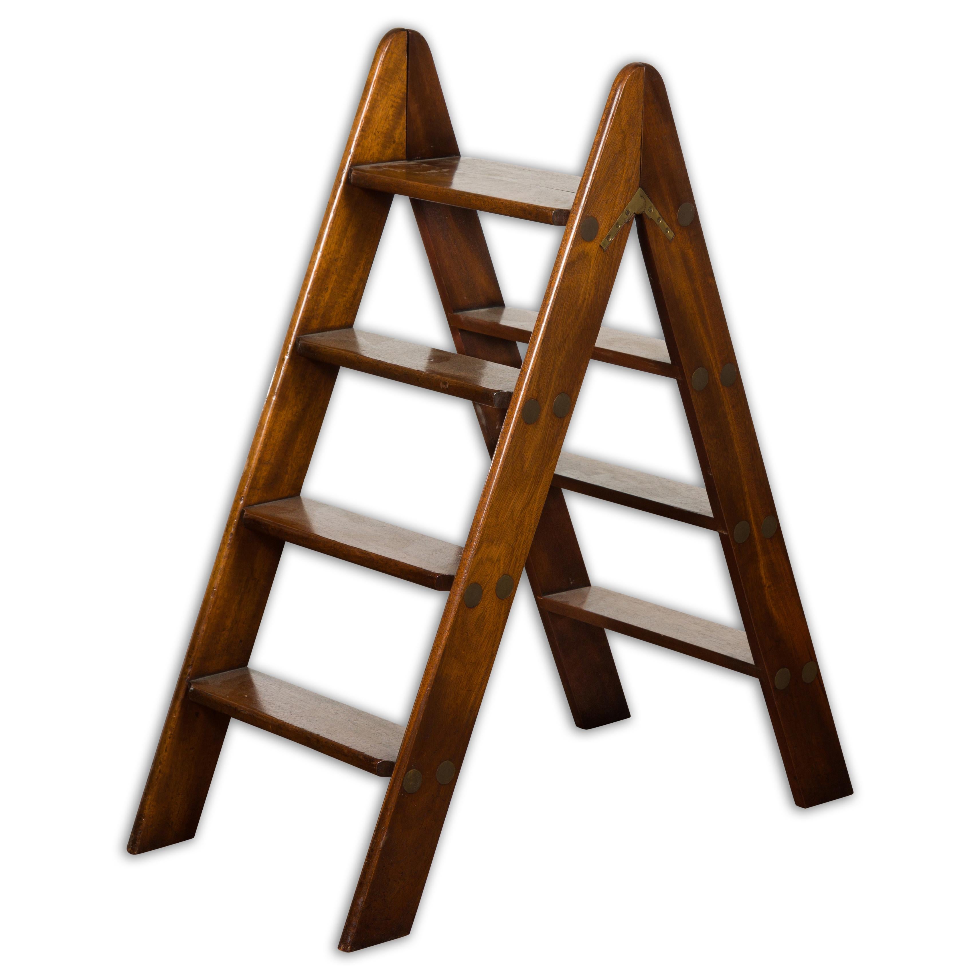 An English oak step library ladder from the 19th century. Step into the pages of history with this 19th-century English oak library ladder, a mix of utilitarian function and classic charm. Crafted from robust oak, this library ladder exudes an