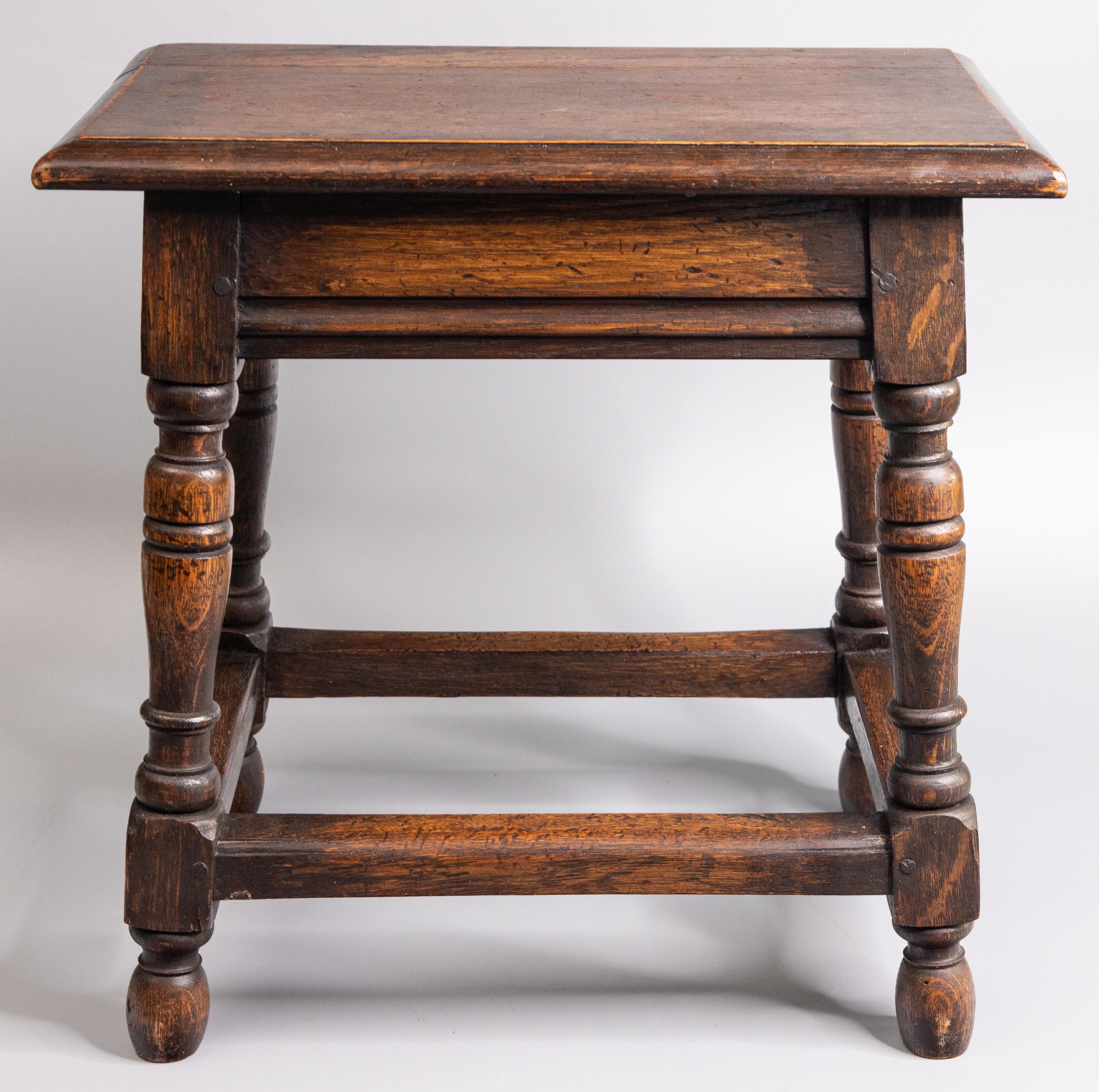 A superb antique 19th-Century English oak joint stool with hand turned legs and beveled edge on the seat. This charming stool would be great for extra seating and also perfect as a side table for beverages or your favorite book.

DIMENSIONS
18ʺW ×