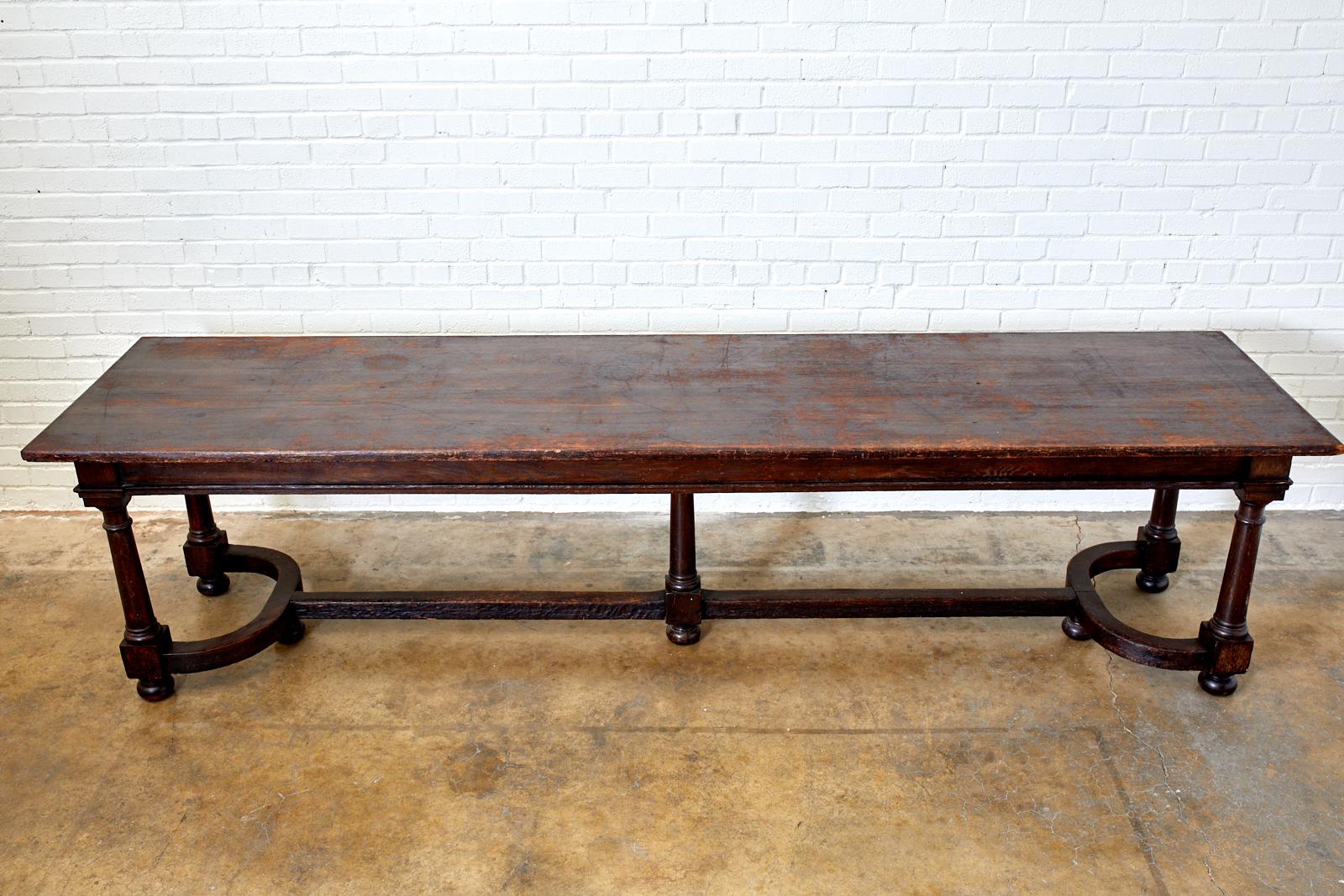 Grand 19th century English refectory, banquet, harvest or dining table. Handcrafted from oak featuring a 10 foot long removable three plank top. The shaped apron is supported by five thick, turned legs with blocks on the bottom and ending with bun