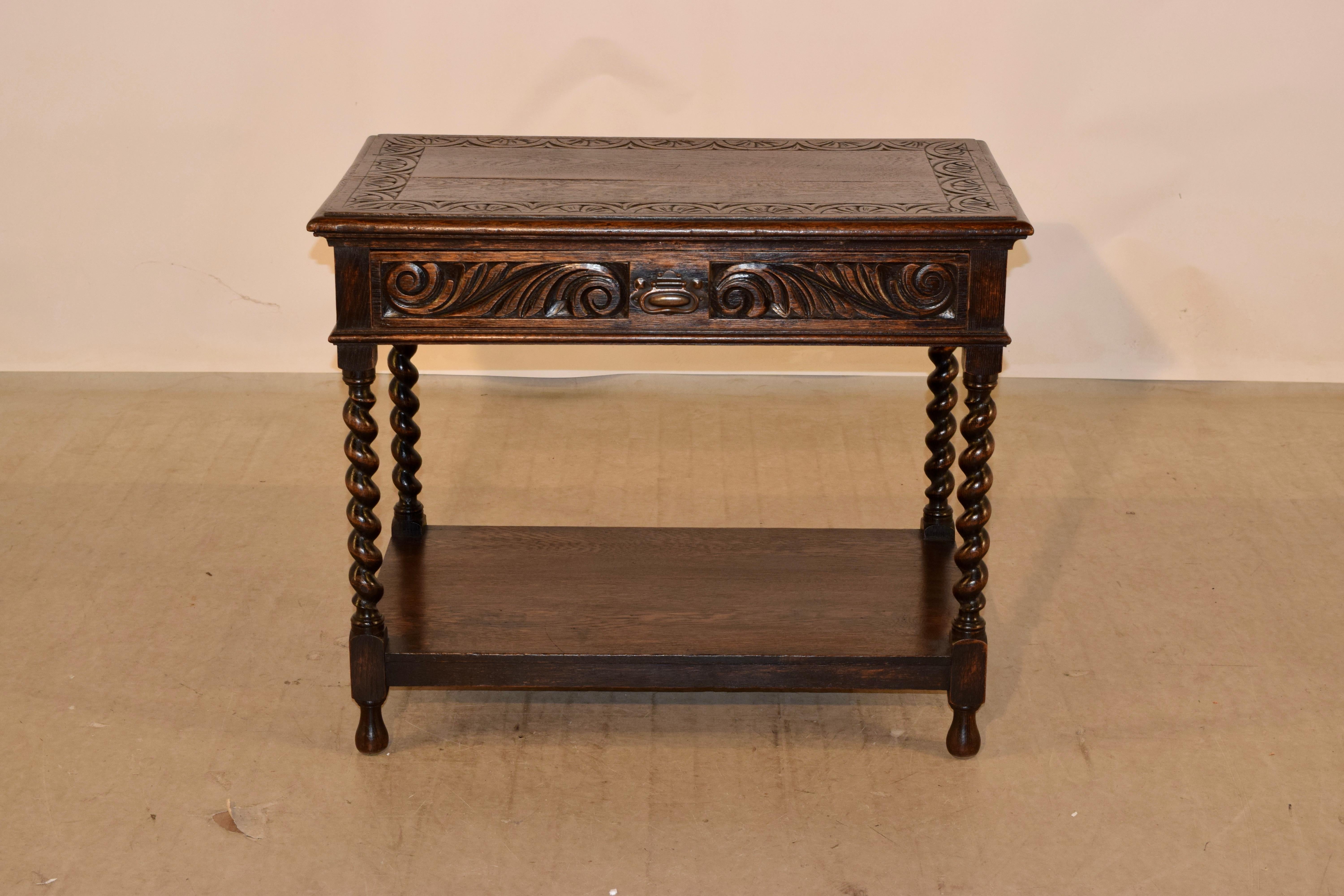 19th century oak side table from England with a carved and banded top, which is finished with a beveled edge. This follows down to a hand carved decorated apron on all four sides, for easy placement in any room, and containing a single drawer in the