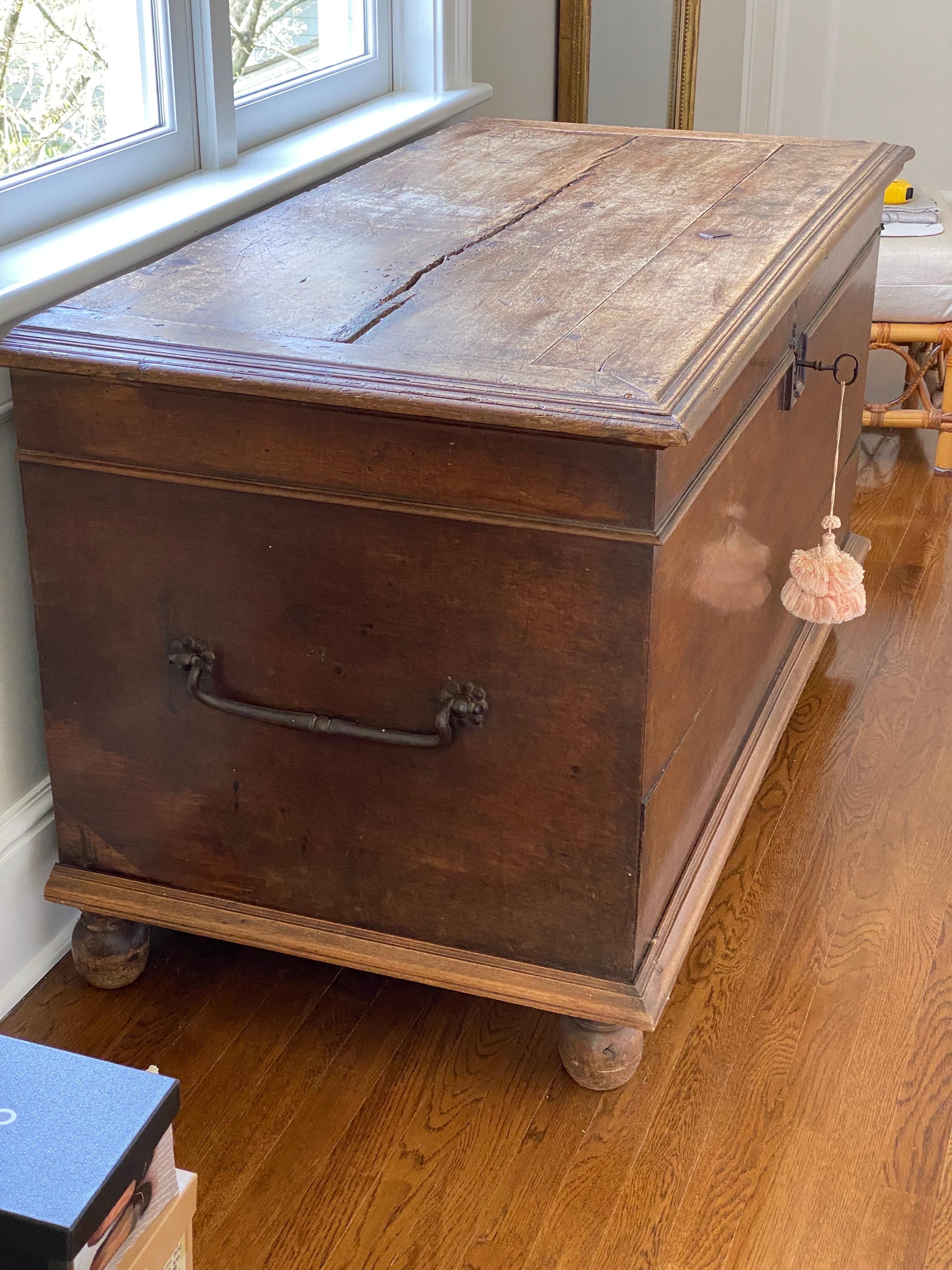 19th Century English oak trunk
A simple rectangular design with iron handles and iron strap hinges on the interior top. Top opens to review lots of storage space inside. Set on bun feet.
Some cracks and separation, wear to finish throughout and