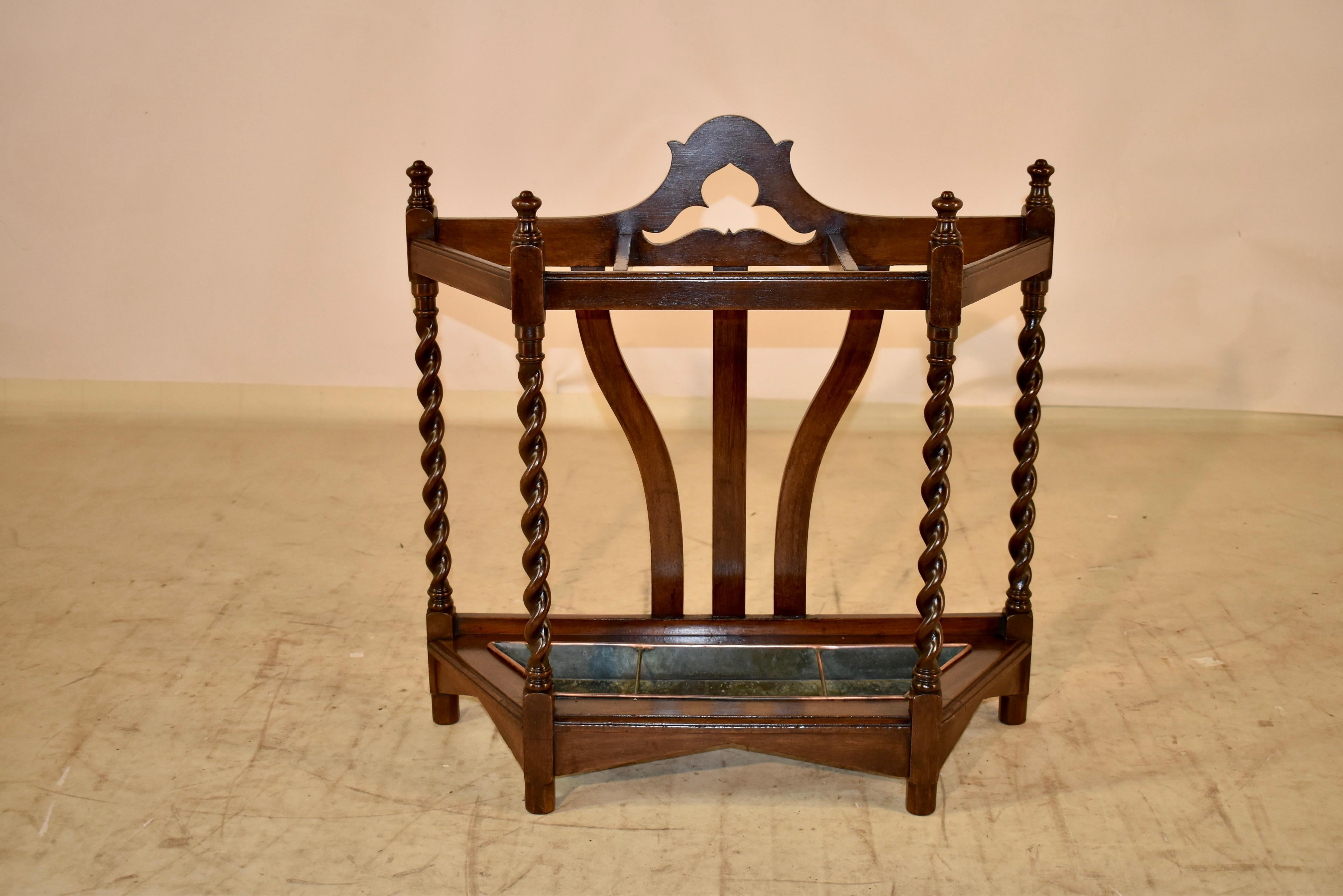 19th century oak umbrella or cane stand from England.  The back has lovely serpentine and scalloped details, which give it a lovely shape and will lend itself to a beautiful silhouette against a wall.  The rails are simple and topped with hand