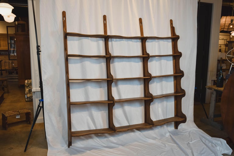 Found in the English countryside, this 19th century 5 tiered English oak wall shelf is a substantial piece with simple traditional lines. It has scalloped sides and a braced back, this beautiful wall shelf would be awesome in any room of the home,