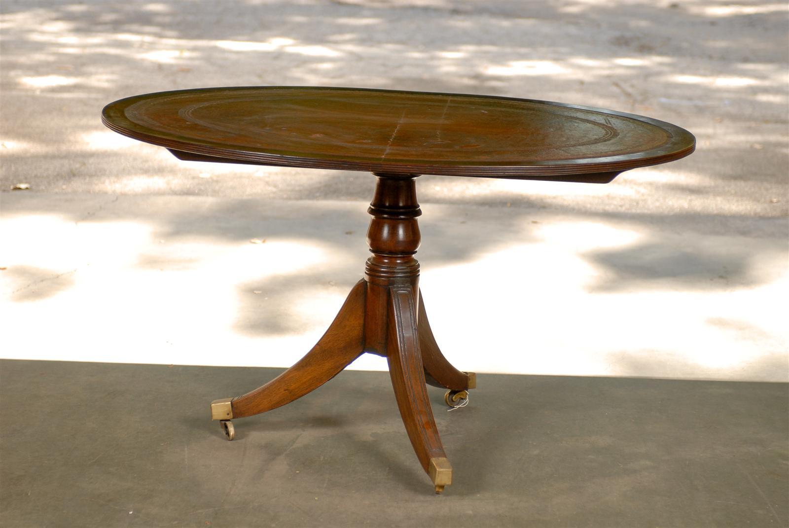 19th century English oval breakfast table with red leather top
Top tilts.