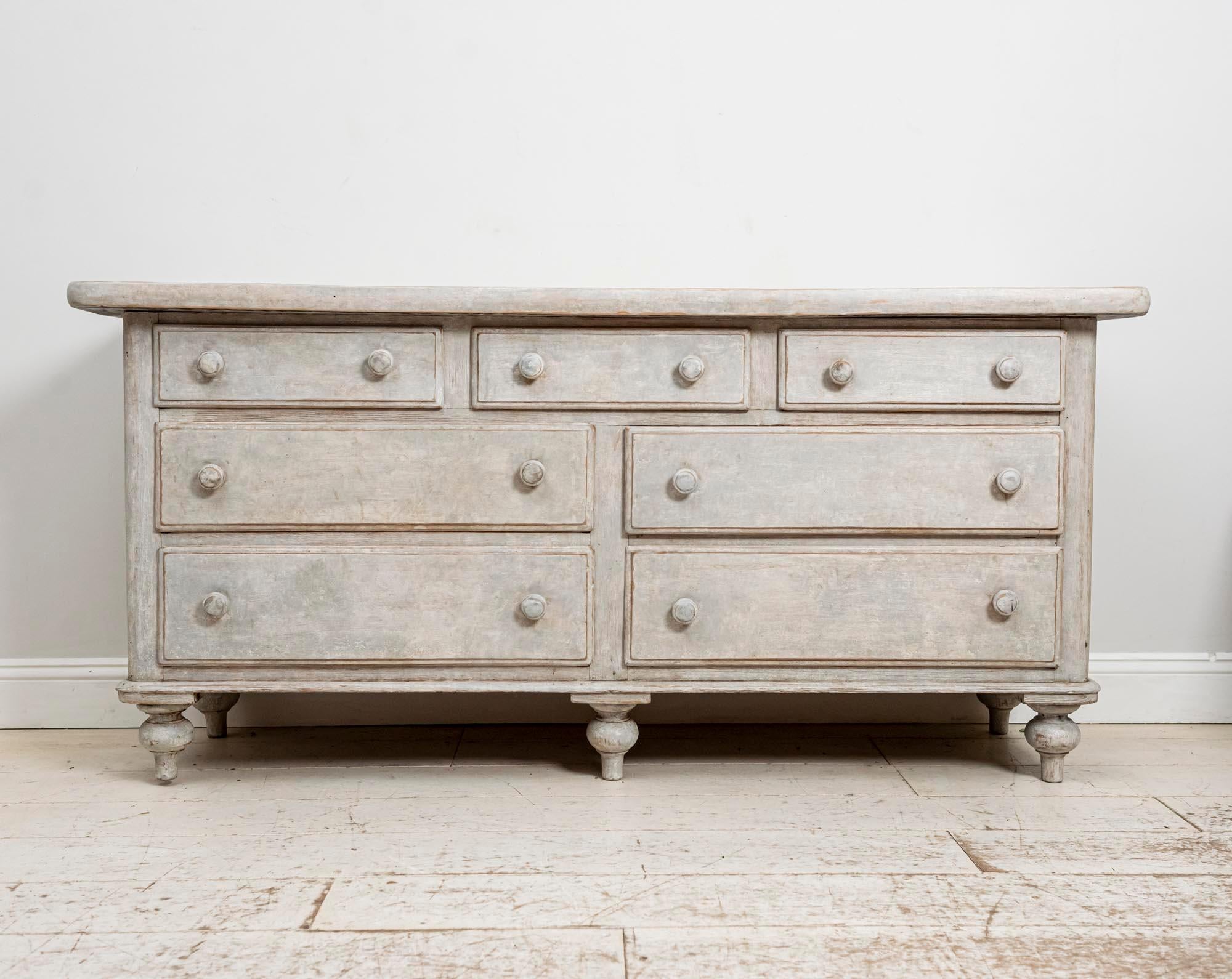 Late 19th century painted pine bank of drawers. Featuring three short drawers which sit over two sets of two longer drawers. A very useful and functional piece of furniture which would be perfect for a kitchen or living room. The chest of drawers