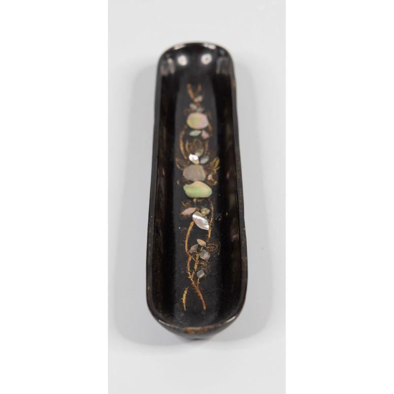 A superb antique English papier mache black lacquered pen tray. This lovely hand made pen tray has a beautiful inlaid mother of pearl floral design with gilt leaves and scrolls. It would make a fabulous gift or desk accessory.


 