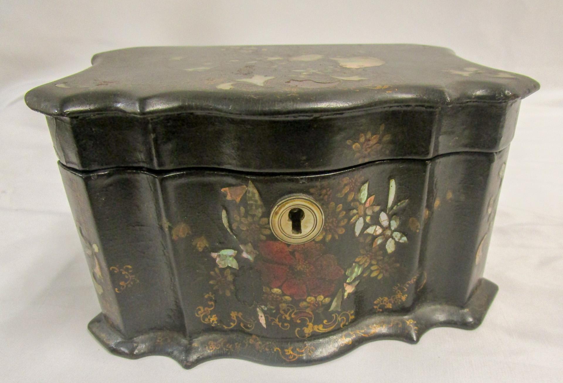 This ornate teacaddy is most likely a product of the renowned English company of Jennens and Bettridge (a partnership between A. Jennens and J. Bettridge 1815–1864) who were highly regarded for producing quality papier-mâché wares. There is a lot of