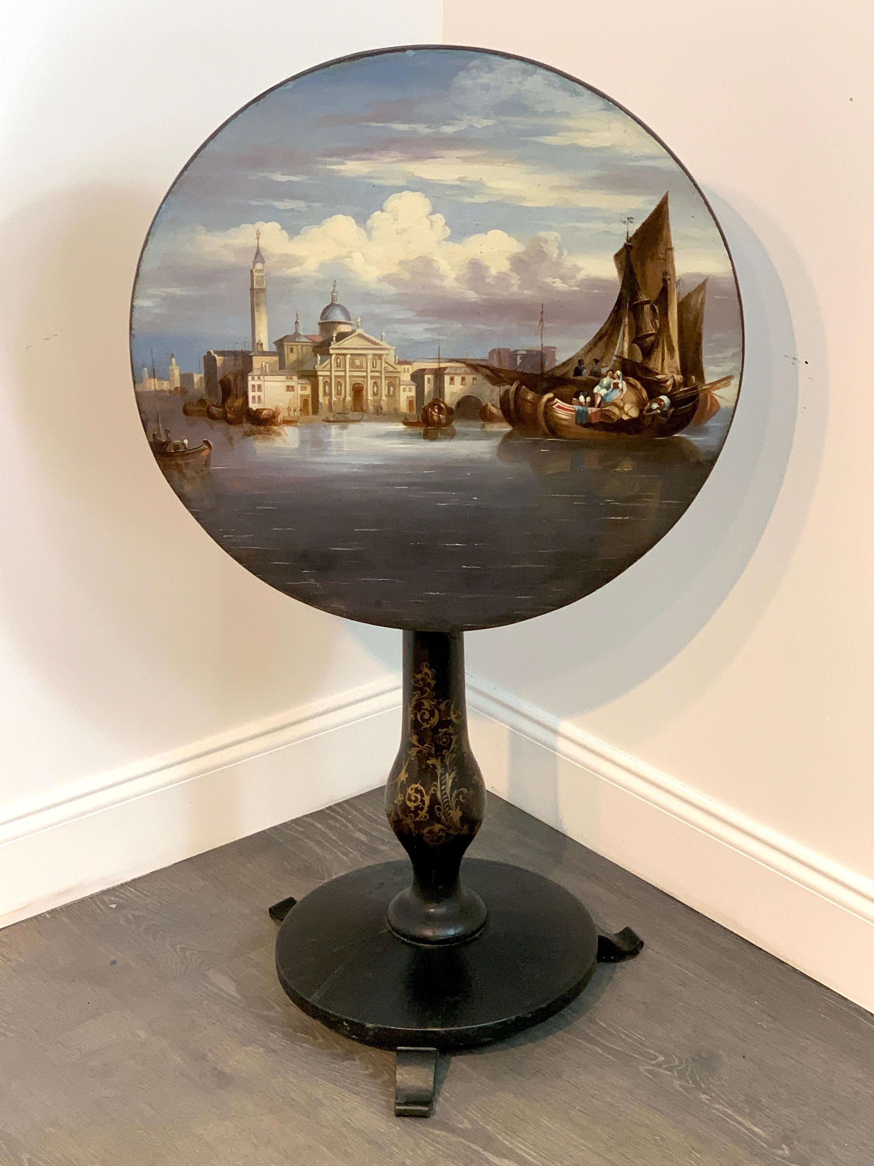 19th century English papier mâché tilt-top table view of St Marks Square, exquisitely painted with a Grand Tour topographical view, on a pedestal base.
Table stands 28.75
