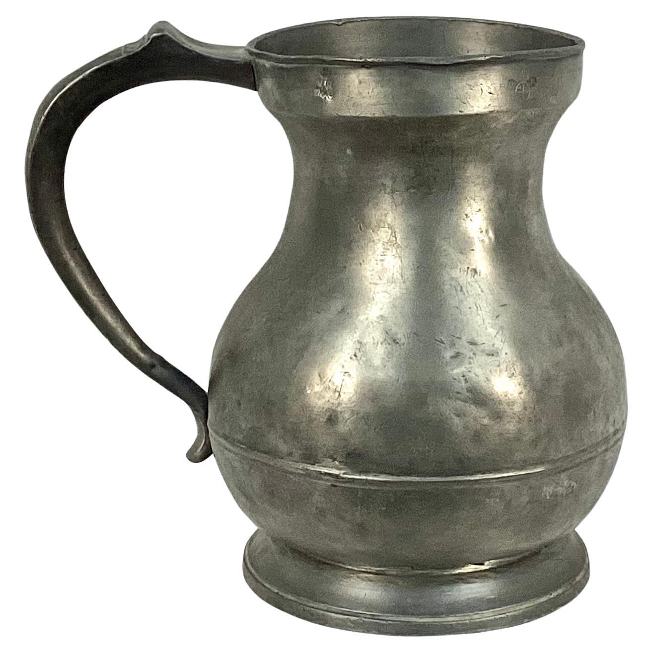 Heavy 19th century pewter one gallon pitcher with large pewter handle.  Stamped Gallon with Queen Victoria certification mark. Etched on underside is name 'Colodny