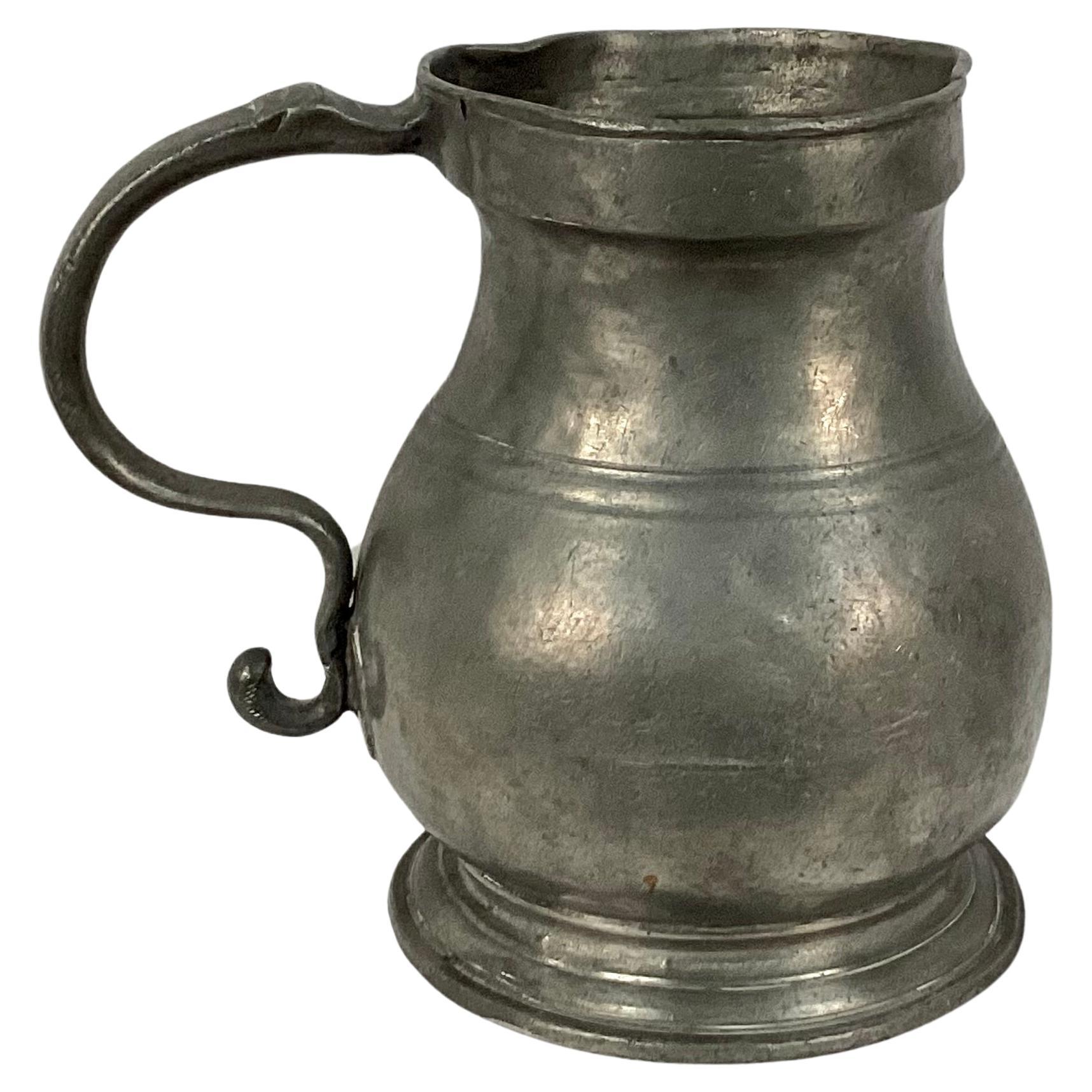  19th century pewter pitcher with pewter handle. Etched on underside is name 'Colodny'. Weighs approximately 4 pounds. Wonderful old patina.  No markings identified. 