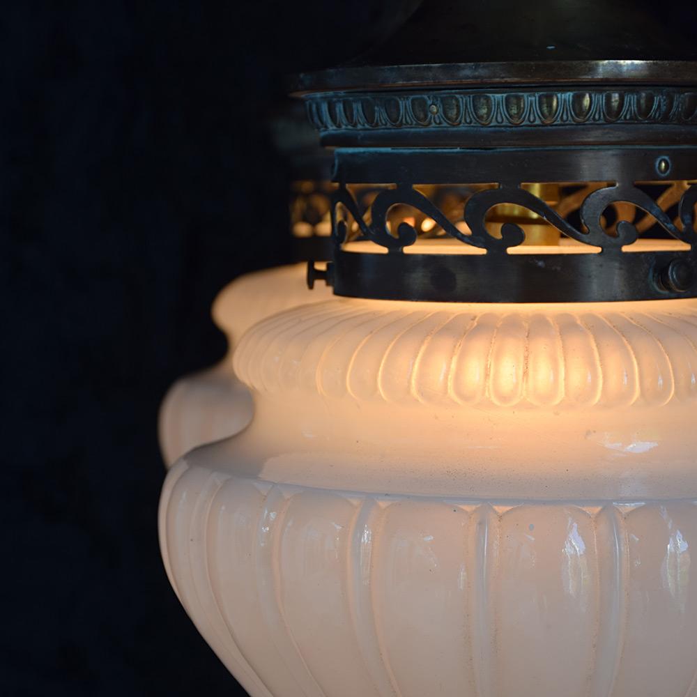 19th Century English Pharmacy lights 
We are proud to offer a pair of mid-19th Century English fluted opaque moonstone glass shade. Supported by their original copper and brass galleries with a wonderful untouched patina. The moonstone shades boast