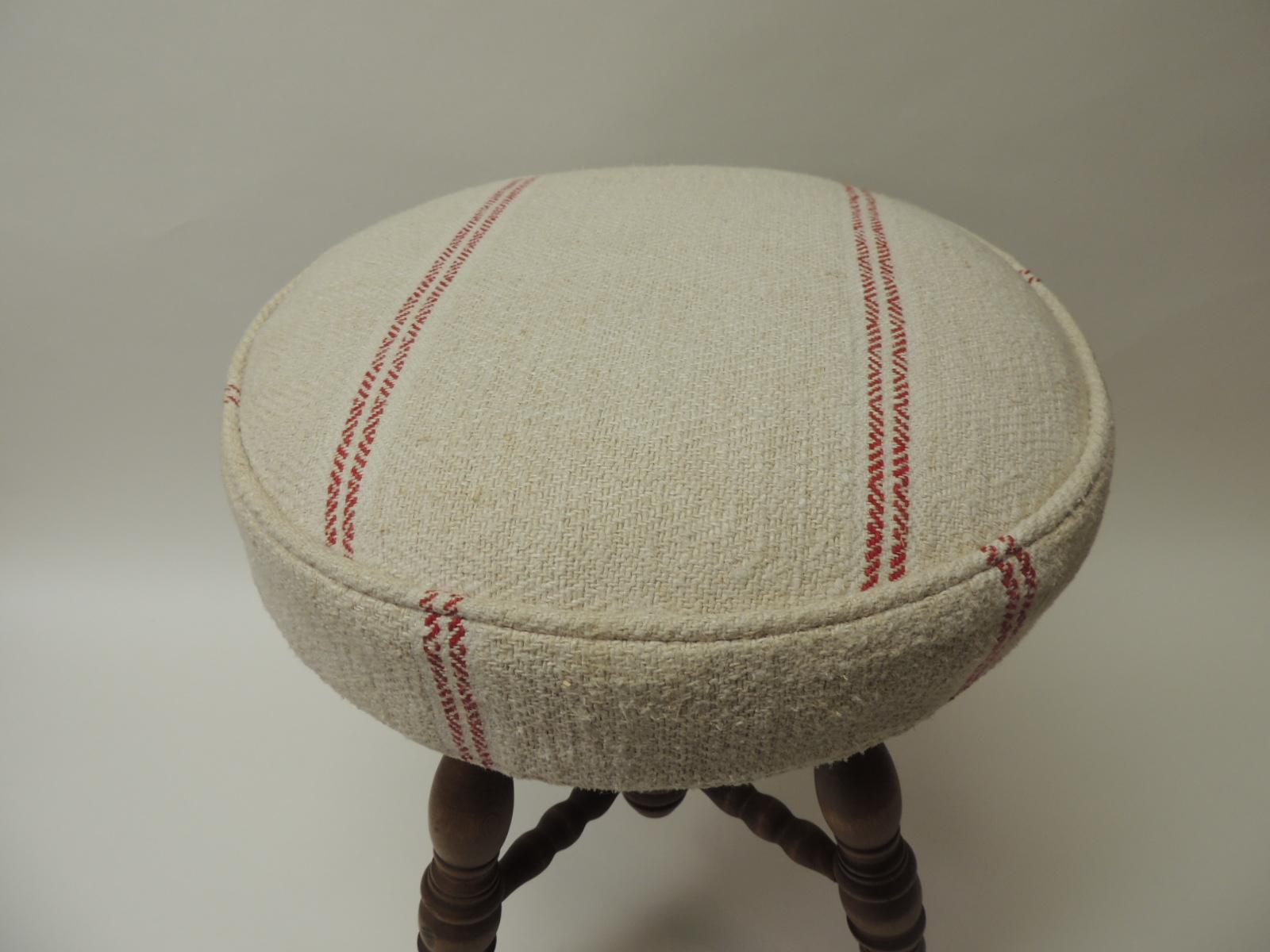 19th century English piano bench or stool
Round oak stool with turned wood legs ending with brass eagle claws holding a glass ball
X based stretcher. Newly reupholstered with a thick natural and red French woven linen sack. Self-welt.
Size: 15.5