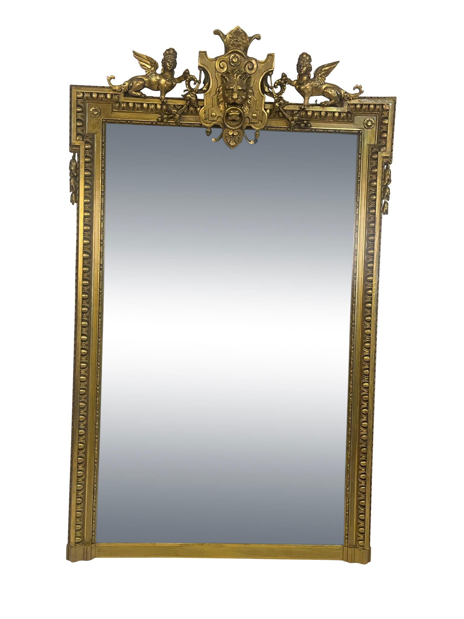 Neoclassical 19th Century English Pier Mirror Decorated with Lions Head and Figural Griffins For Sale