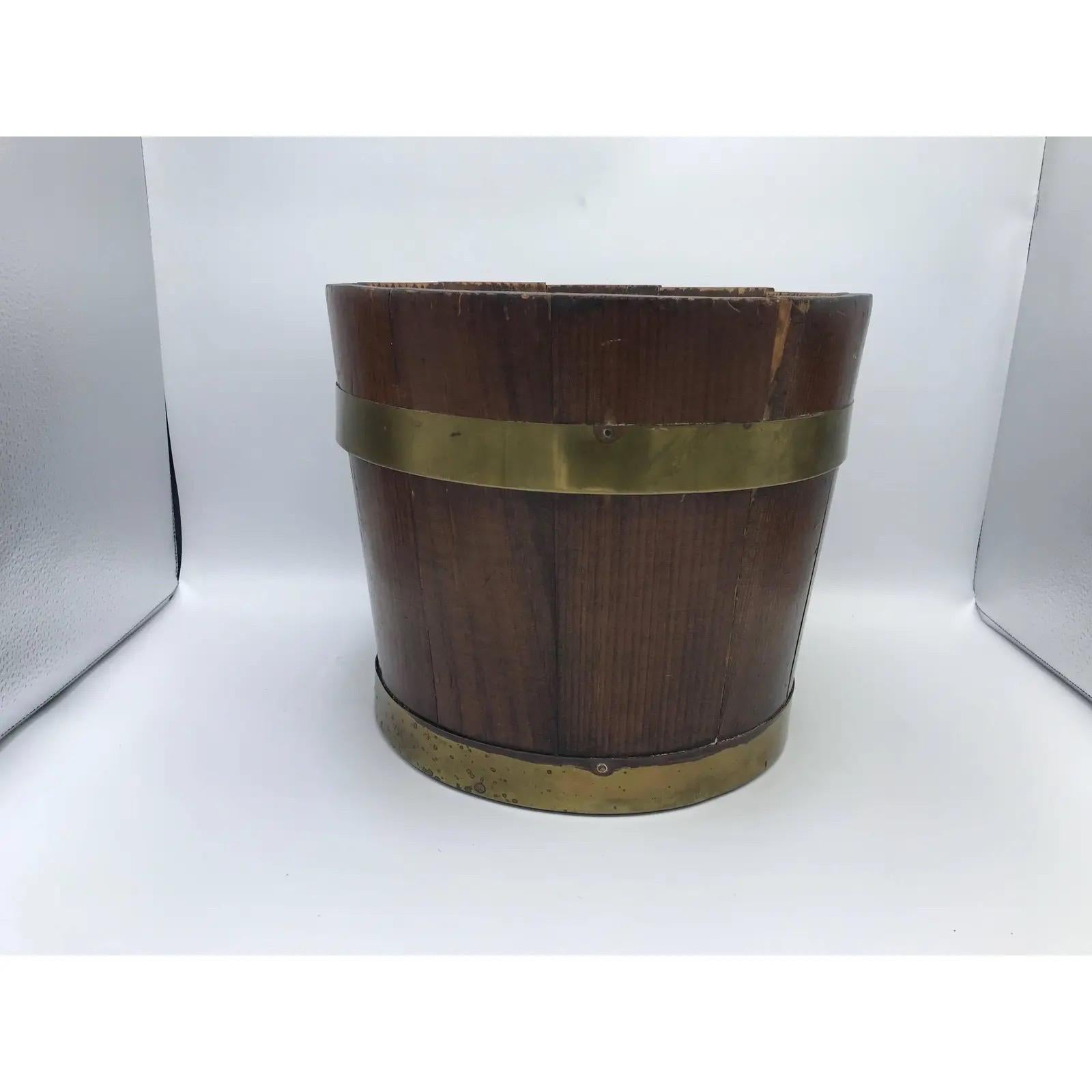 Offered is an exquisite, late 19th century English pine bucket with a brass banded collar. Could be used as a cachepot planter, centerpiece, or waste bin with appropriate liner. Lovely all-over patina to brass.