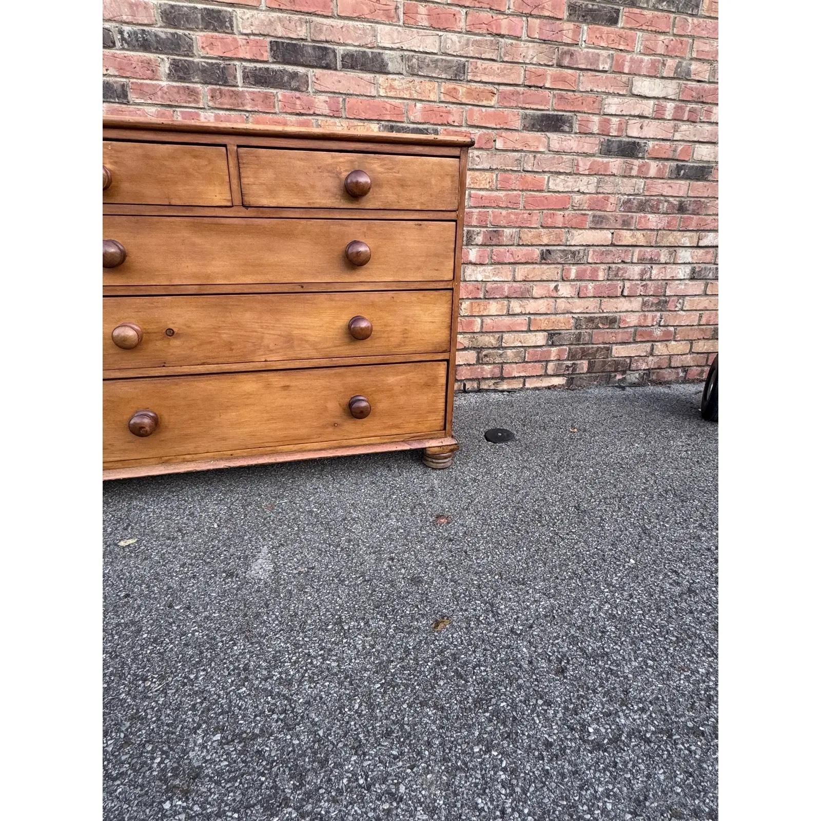 This is a lovely antique pine chest! This piece dates to the 19th century and has lovely patina. The wood has a warm glow, that is accented perfectly by the darker stained knobs. Being a two over three design with a casual simple feel. This chest