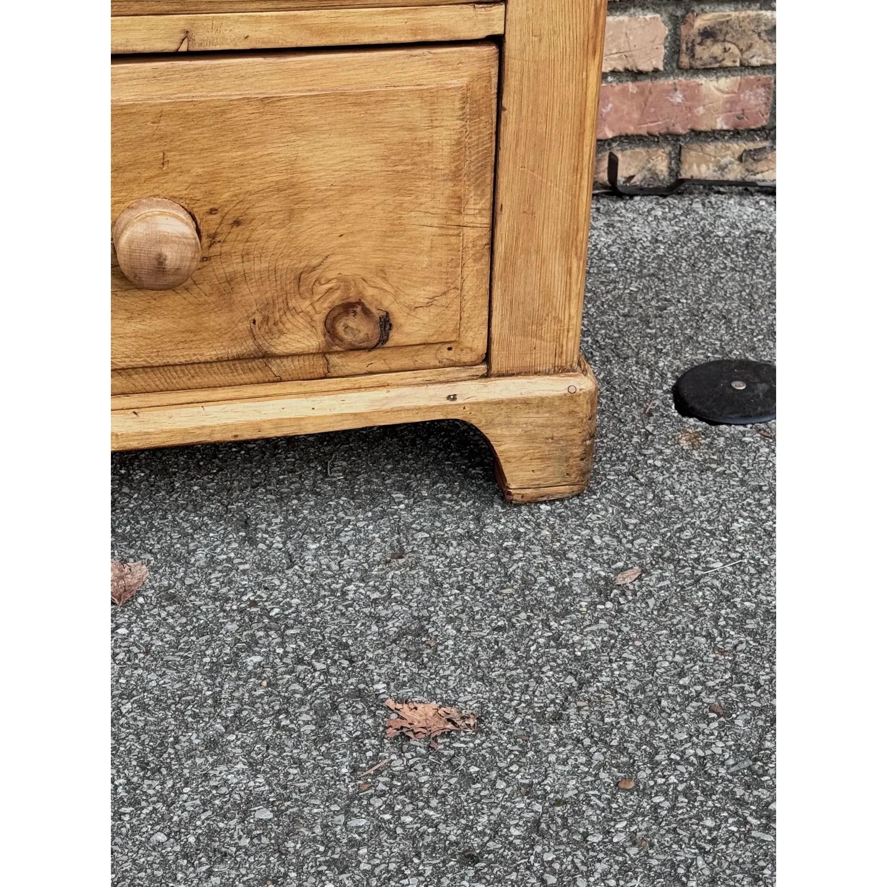 This is a lovely antique pine chest! This piece dates to the 19th century and has lovely patina. The wood has a warm glow, that is accented perfectly by the darker stained knobs. Being a two over two design with a casual simple feel. This chest