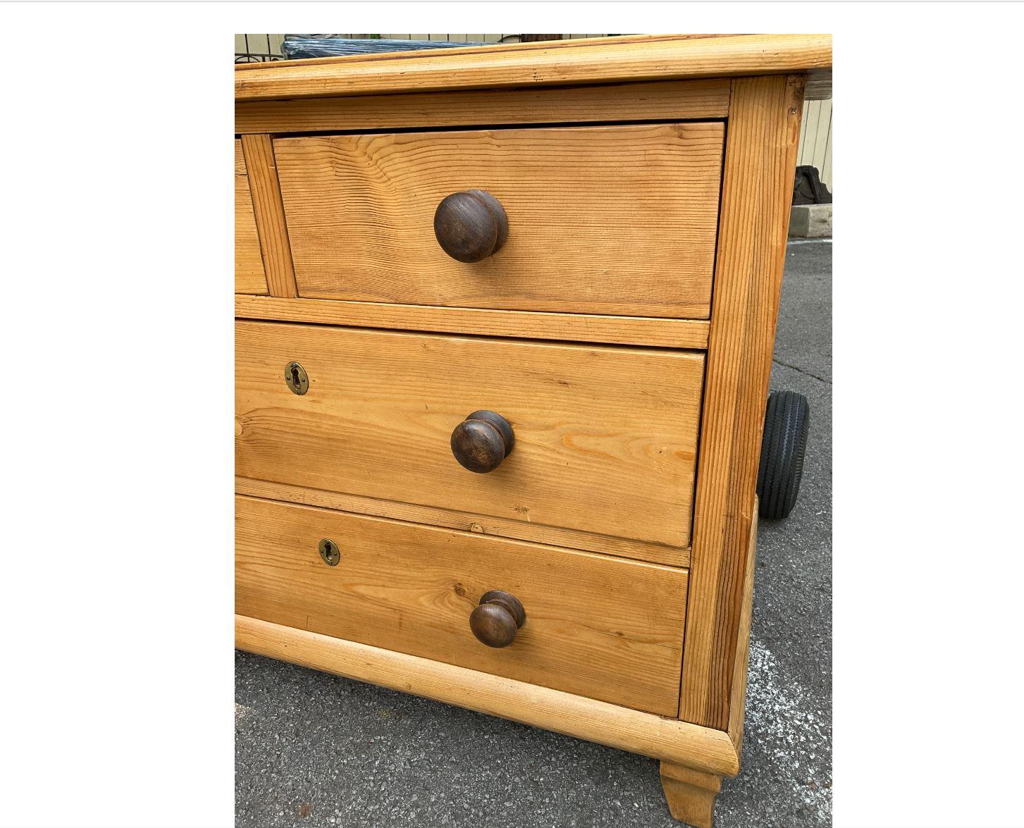 This 19th Century English pine chest has a beautiful warm tone patina with dark stained knobs. All of the drawers slide perfectly, making it easy for you to get items in and out of it. The colors, style and design of this piece all combine to make