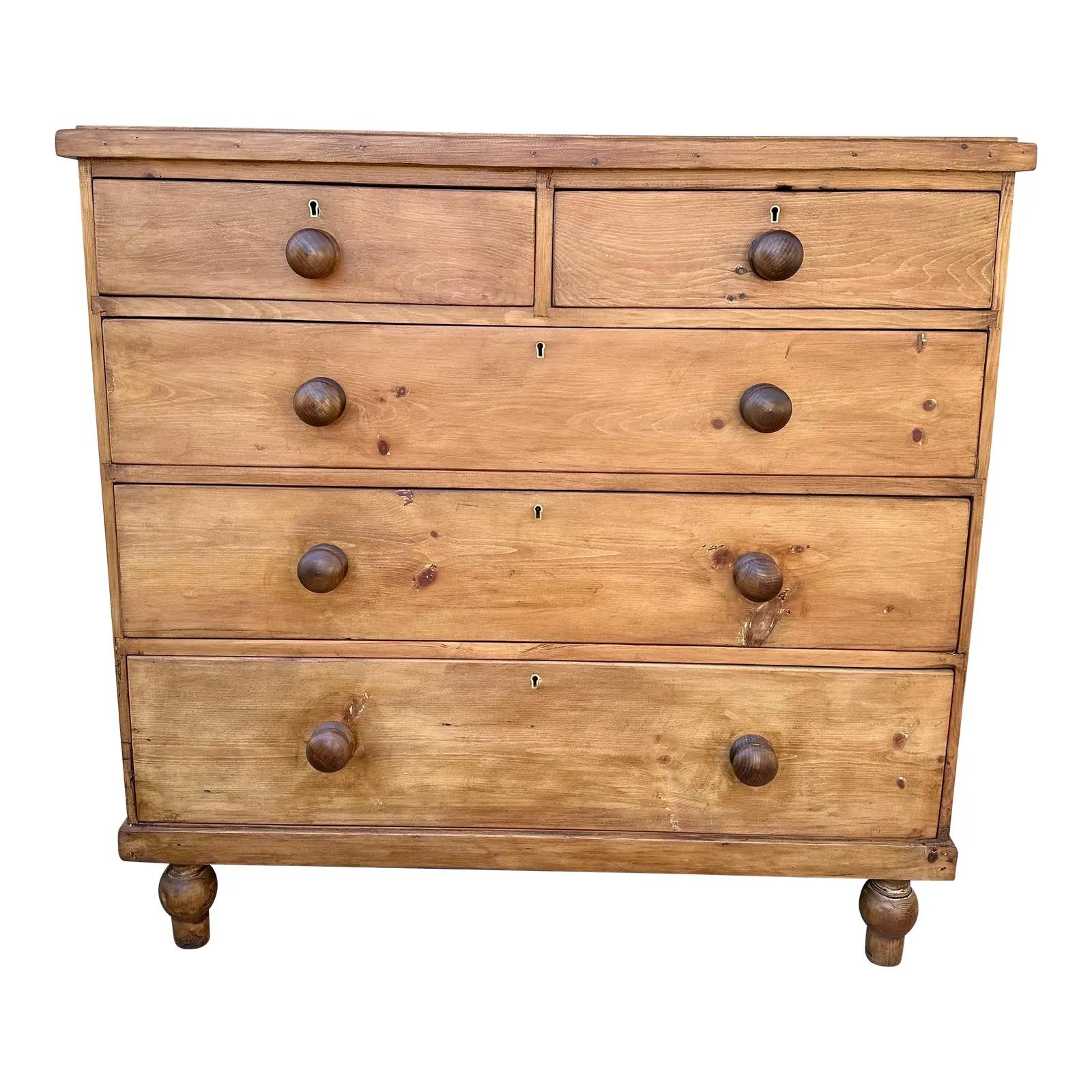 This is a lovely antique pine chest! This piece dates to the 19th century and has lovely patina. The wood has a warm glow, that is accented perfectly by the darker stained knobs. Being a two over three design with a casual simple feel. This chest